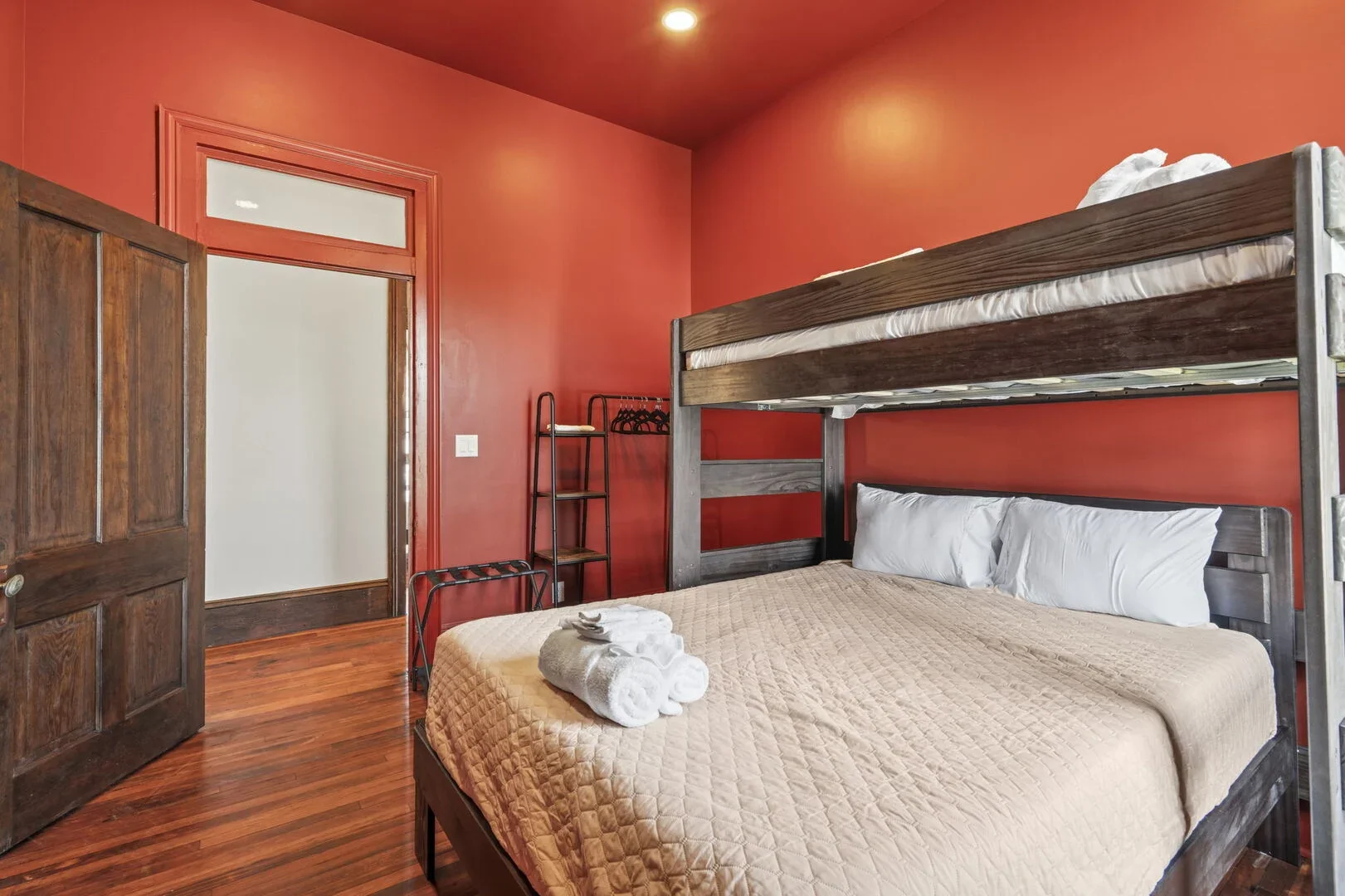 The Mollie Walters Terra Chamber with a twin over queen bunk bed and clothing rack.