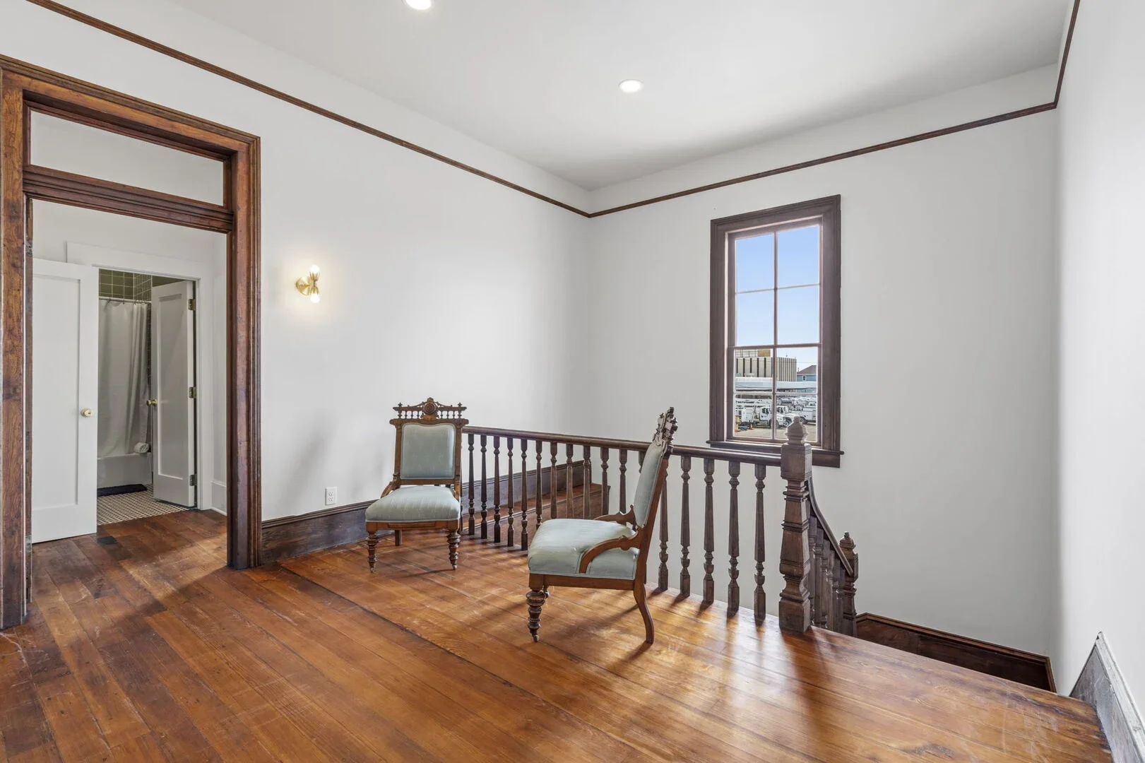 Mollie Walters House restored staircase with two vintage armchairs