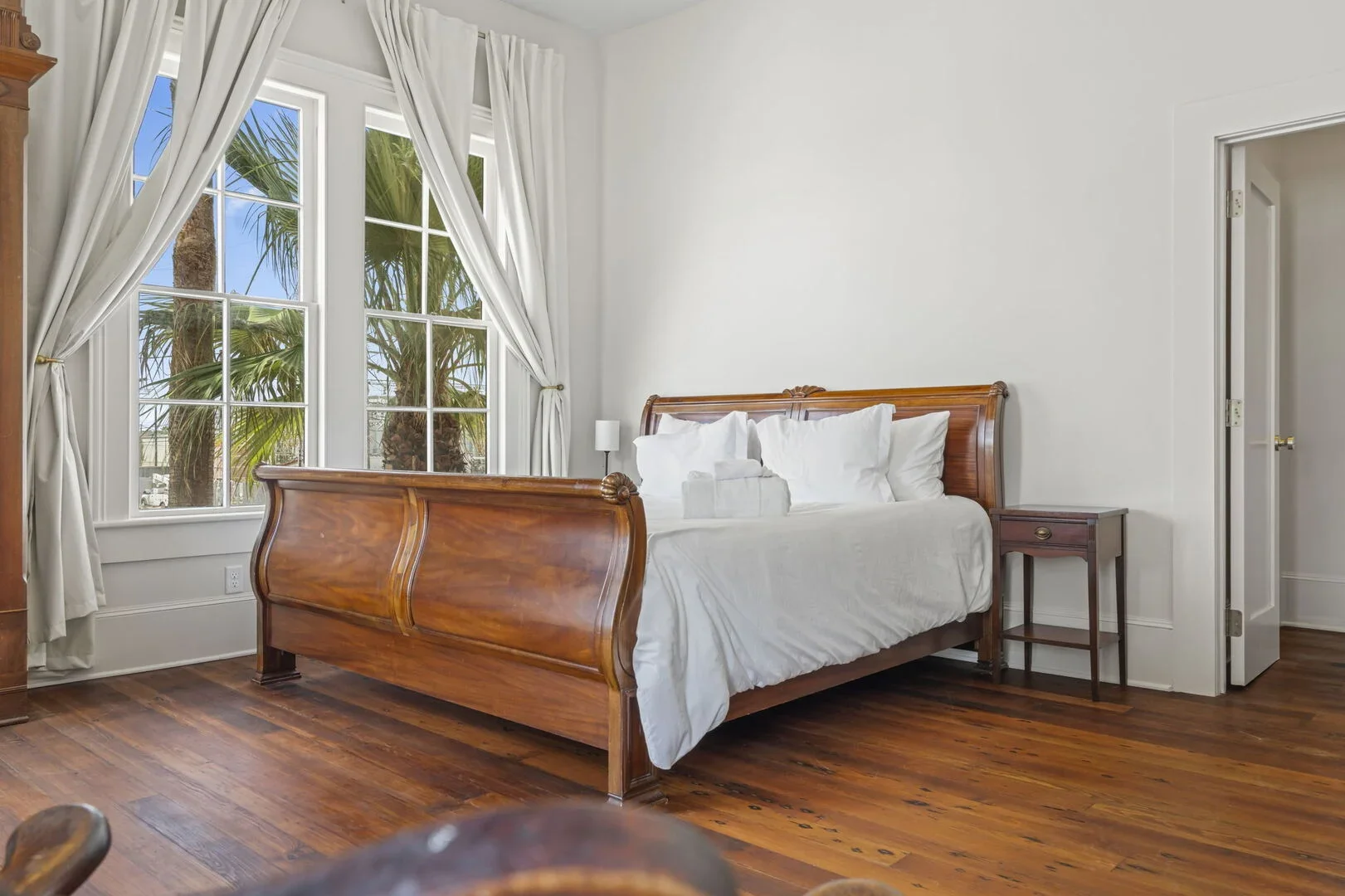 The Mollie Walters Pearl Chamber with a wooden king-sized bed and side table