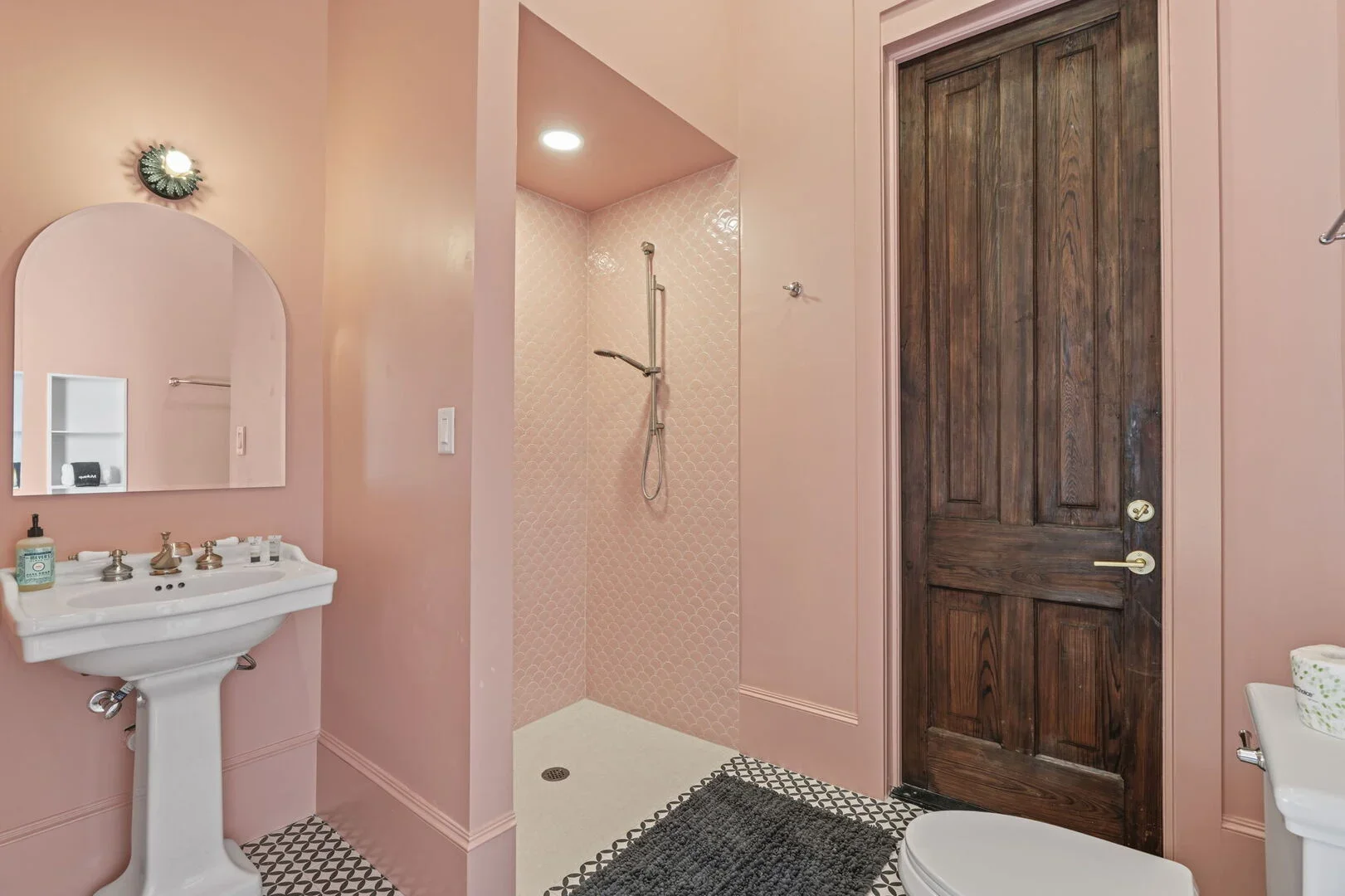 The Mollie Walters Madam's Chamber Bathroom with a pedestal sink, a toilet, and a shower