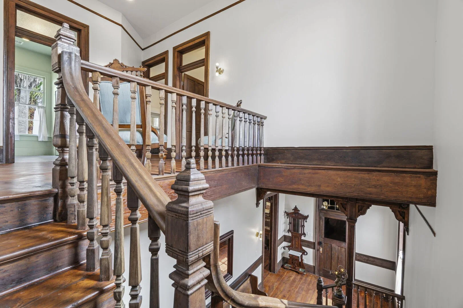 Mollie Walters House restored wooden staircase with ornate railing leading to second floor