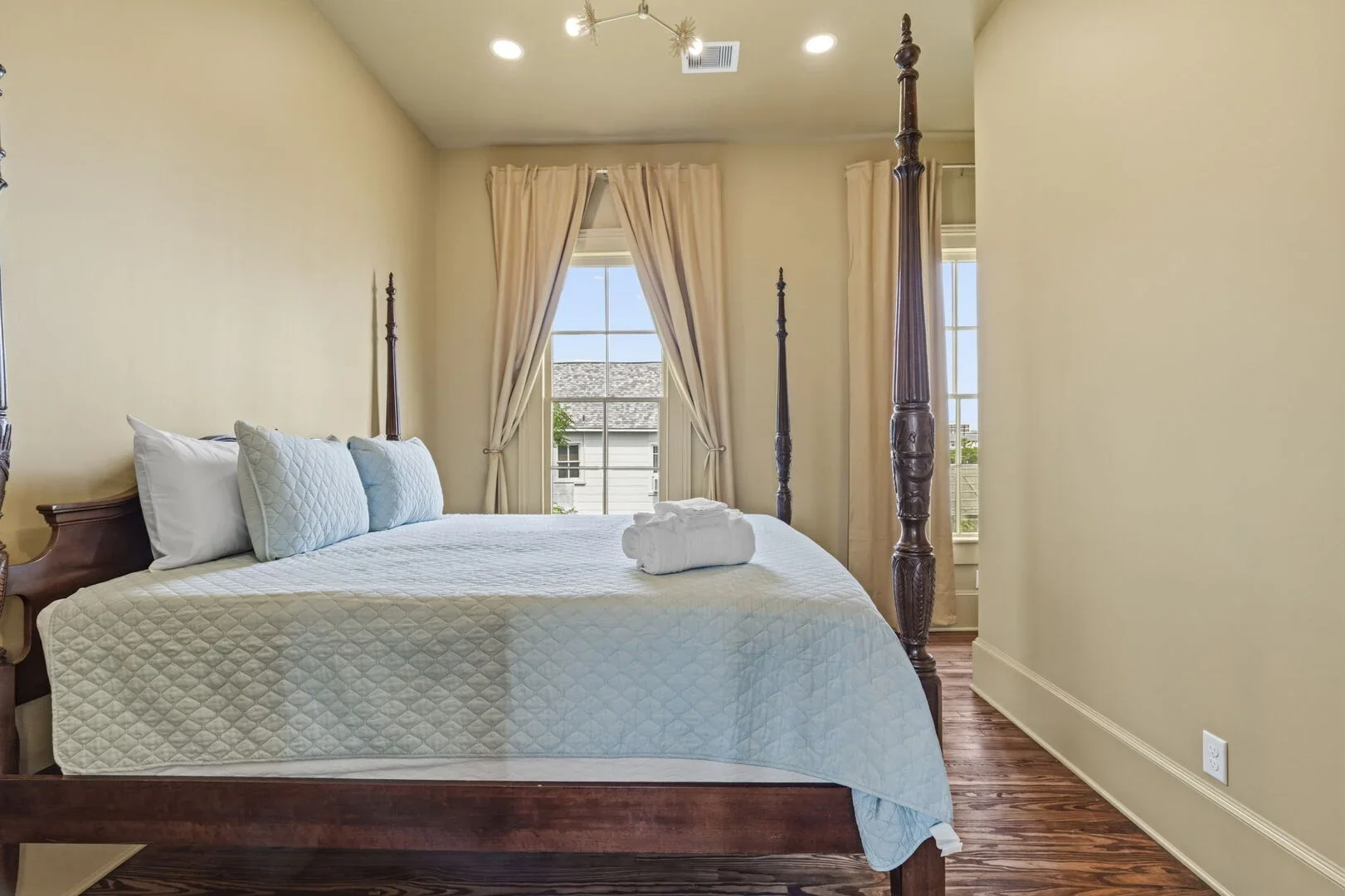 Golden Chamber in the restored 1886 Mollie Walters House with a wooden four-poster queen size bed