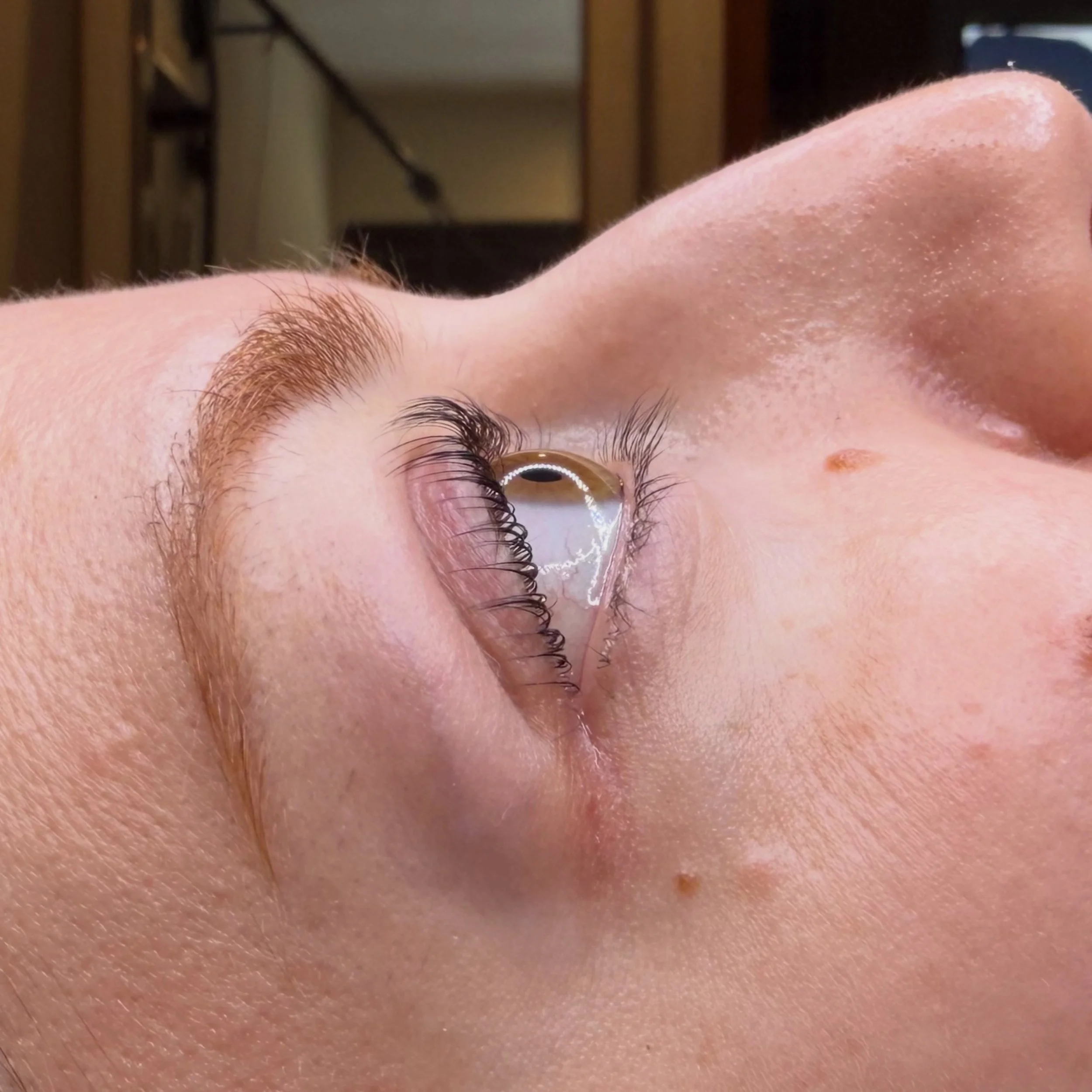 Side profile of a Korean lash lift highlighting naturally lifted eyelashes