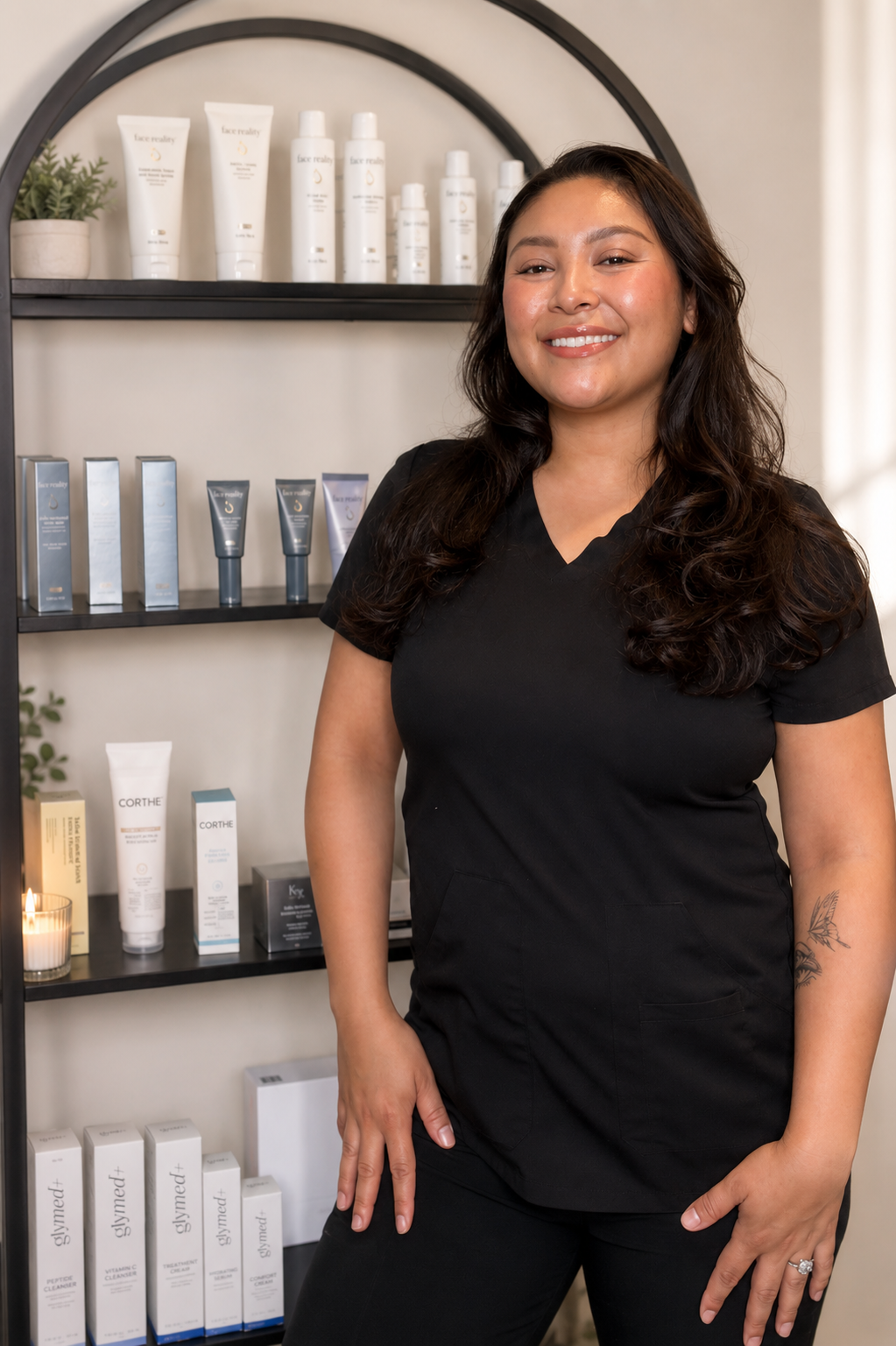Licensed esthetician standing in a professional skincare studio with medical-grade skincare products