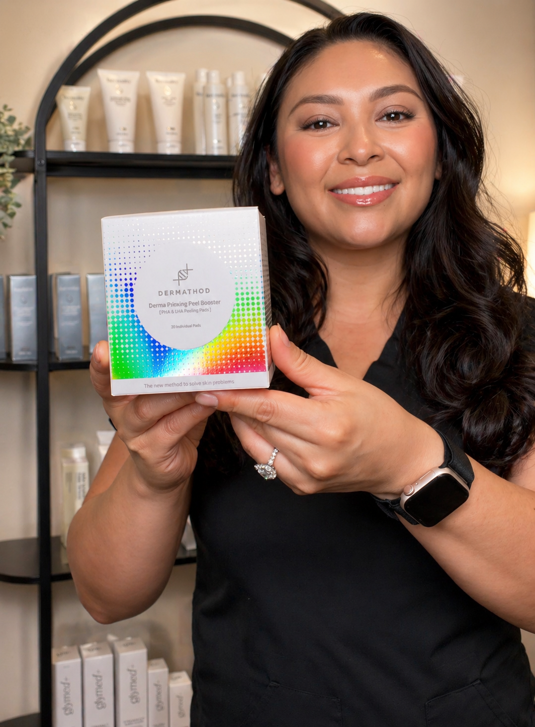 Licensed esthetician holding a professional skincare product for advanced treatments