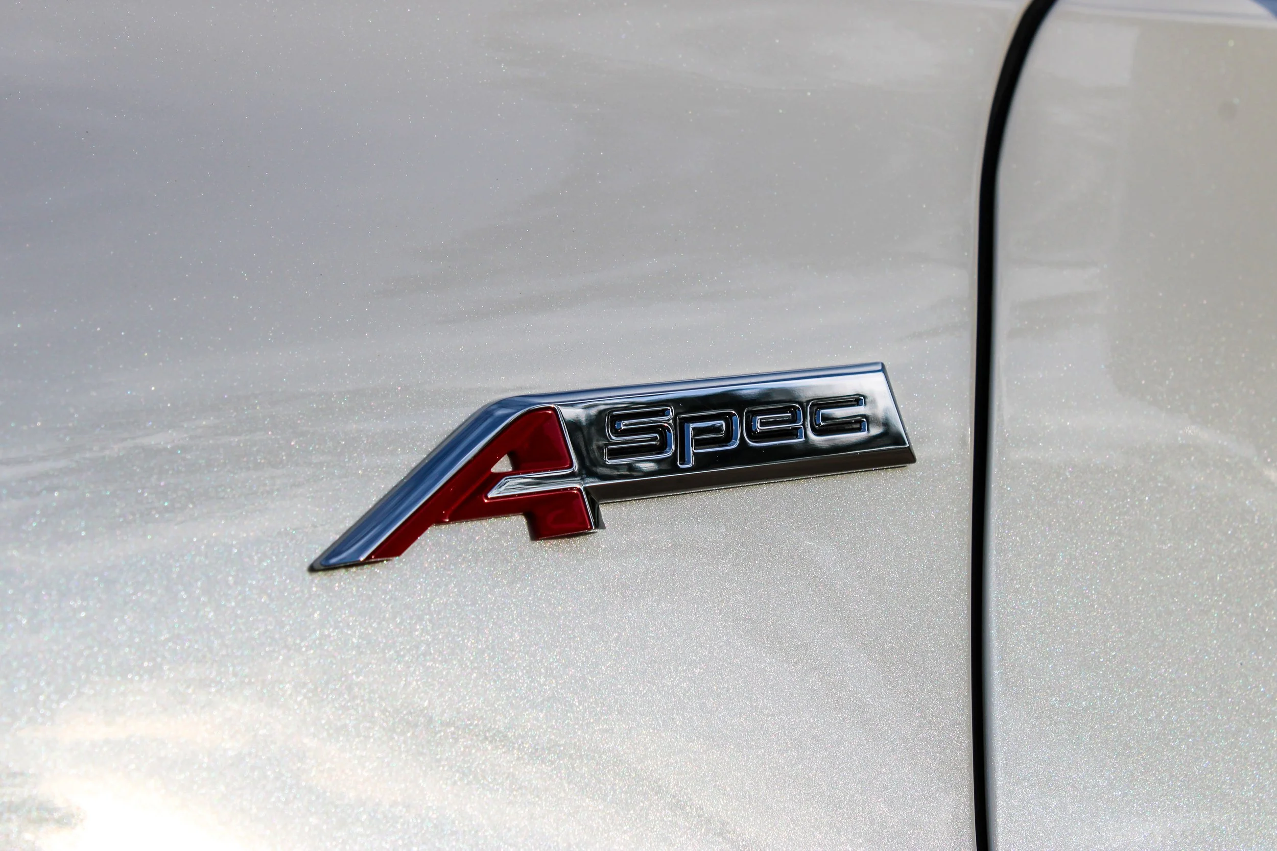 Close-up of A-Spec badge on freshly detailed sports car