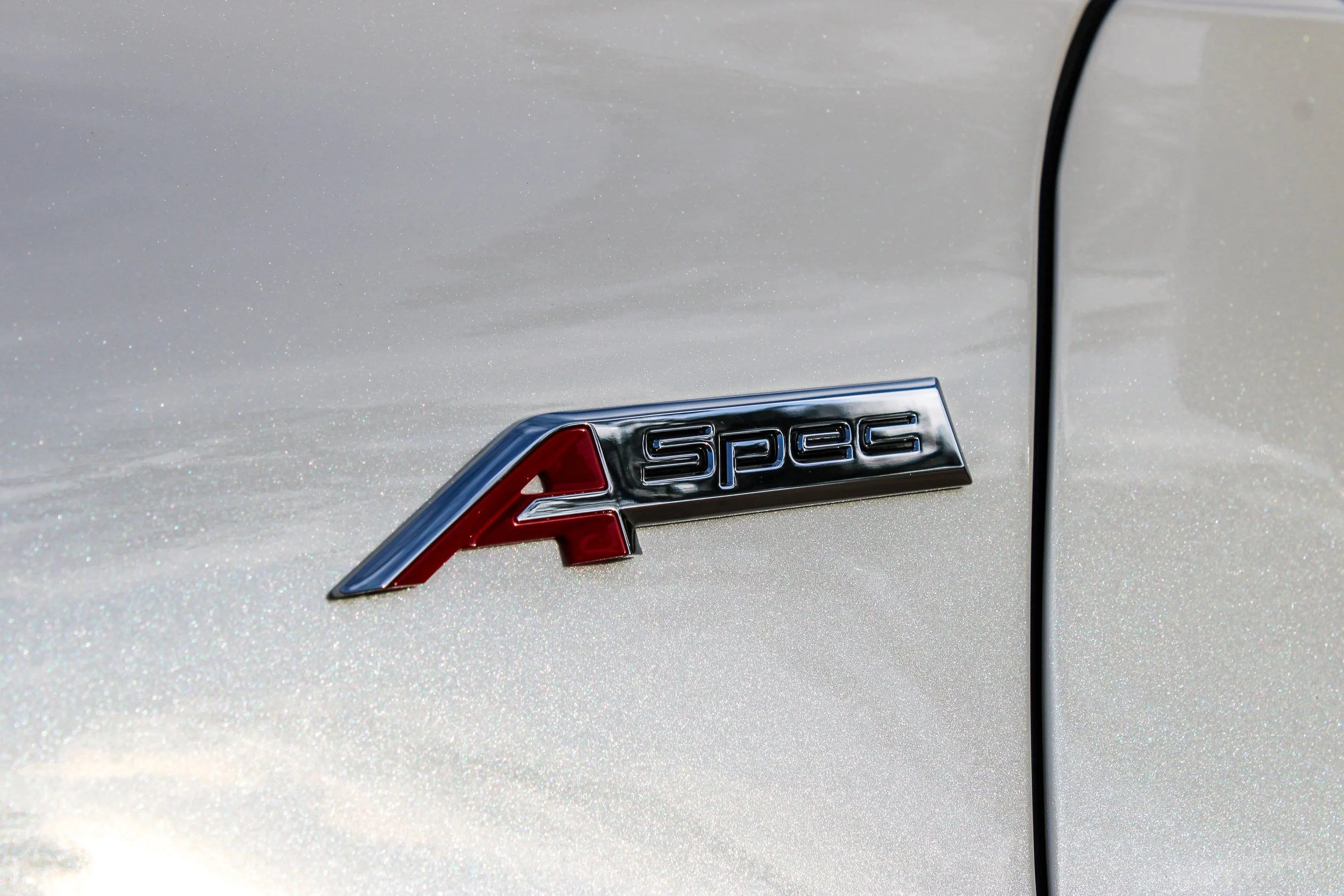 A-Spec badge detail on white sports car exterior
