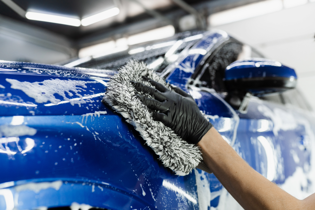 Professional mobile car detailing service washing blue vehicle in Newnan GA