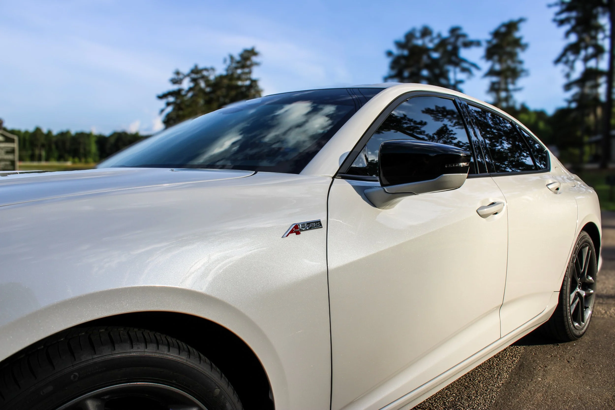 White Acura TLX automotive photography by the water in Senoia GA