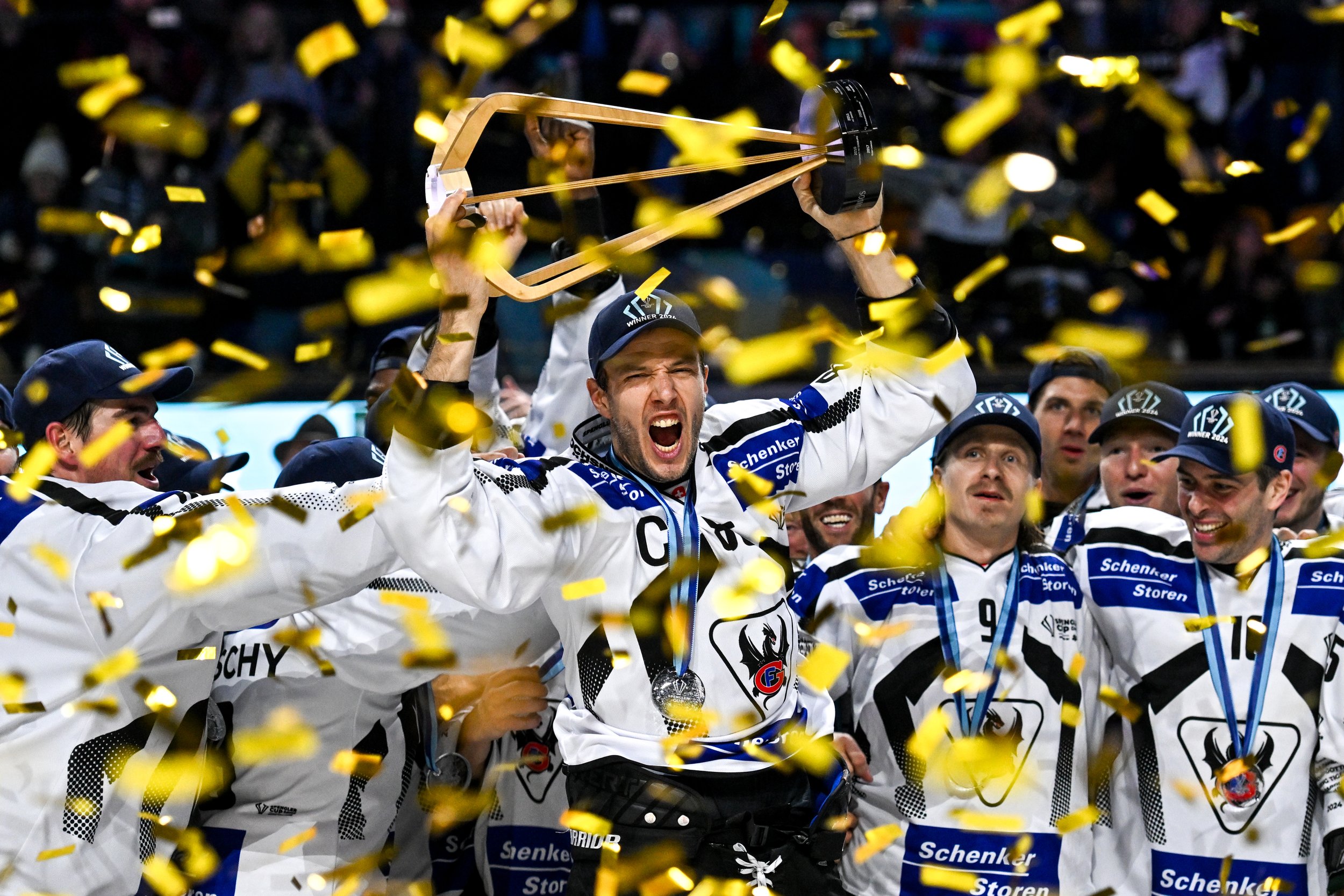  Fribourg captain Julien Sprunger shows his emotion as he raises the Spengler Cup 