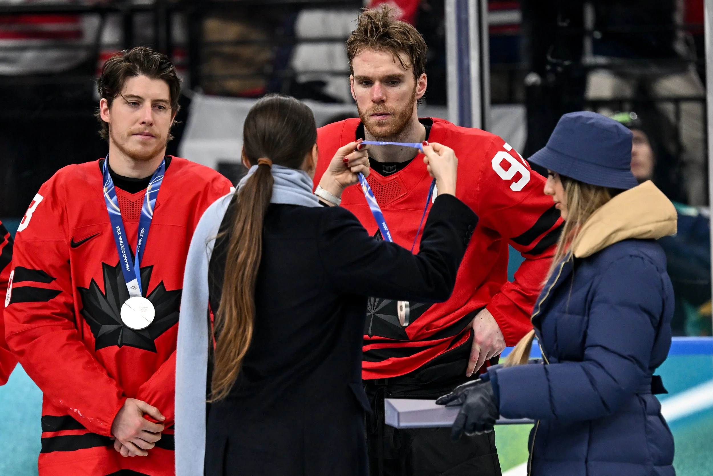  Connor McDavid looks dejectedly at the silver medal he is about to receive 