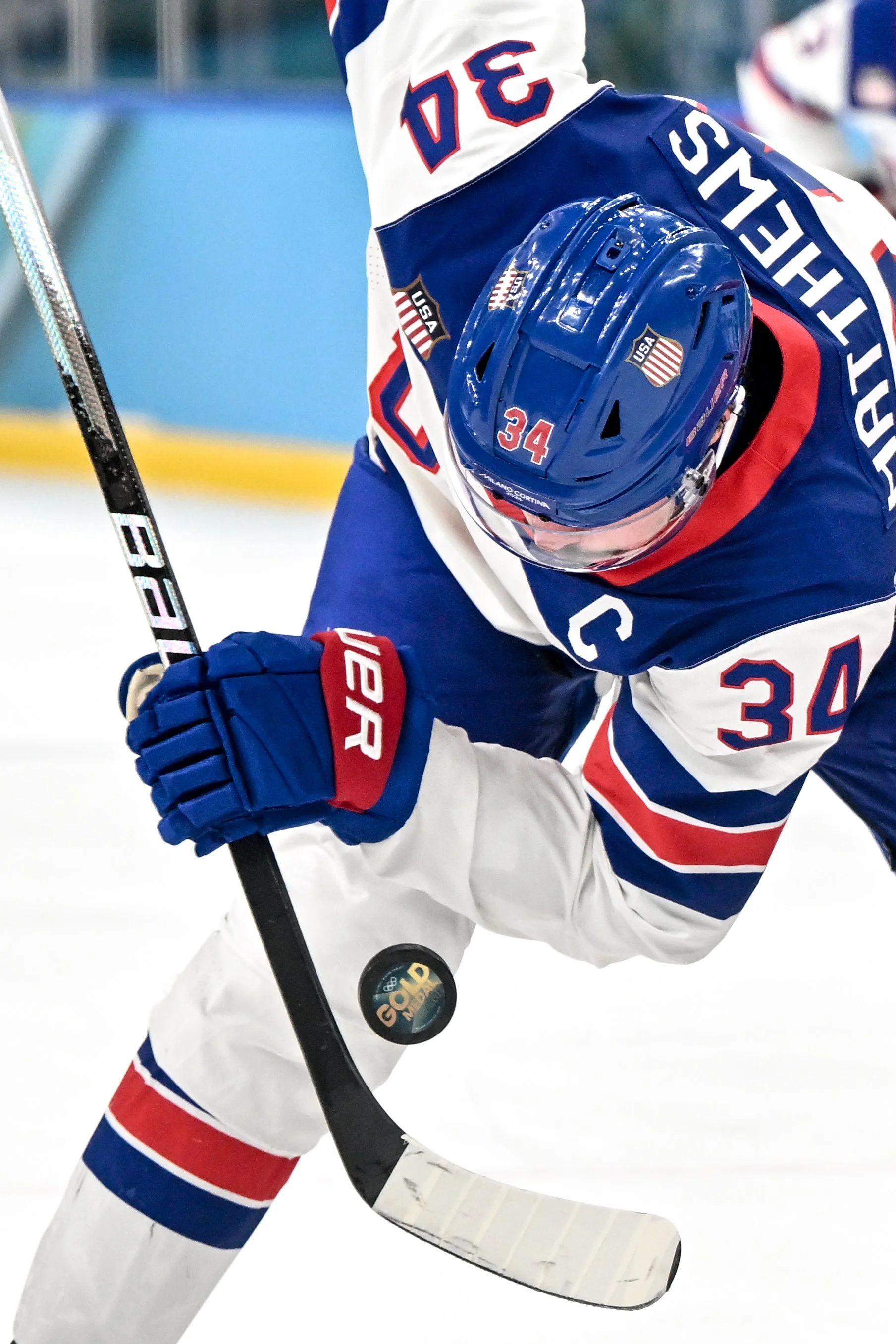  Auston Matthews looks at the puck bearing the logo of the Olympic gold medal game 