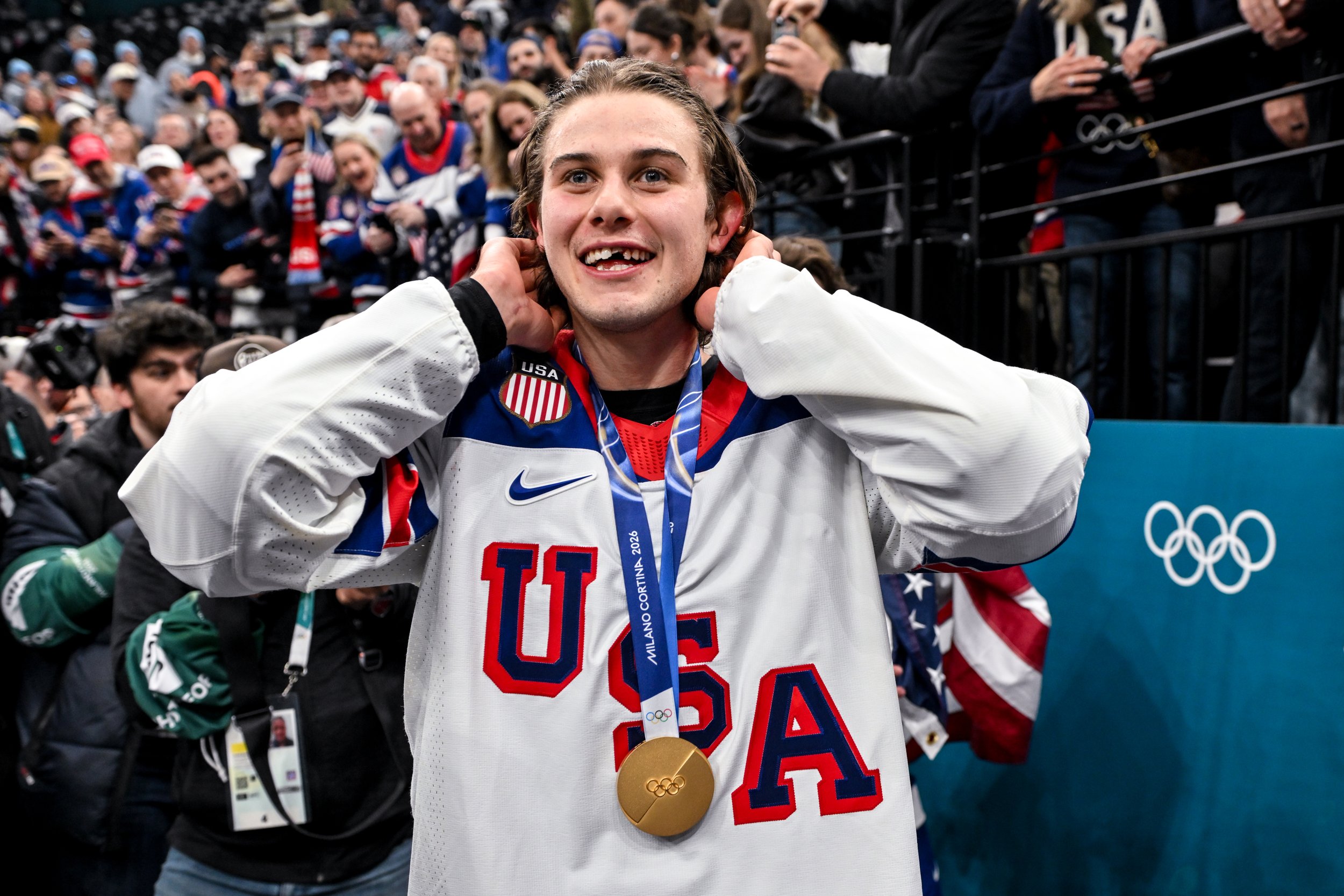  Jack Hughes celebrates winning the Olympic gold medal by showing the tooth he lost in the final against Canada 