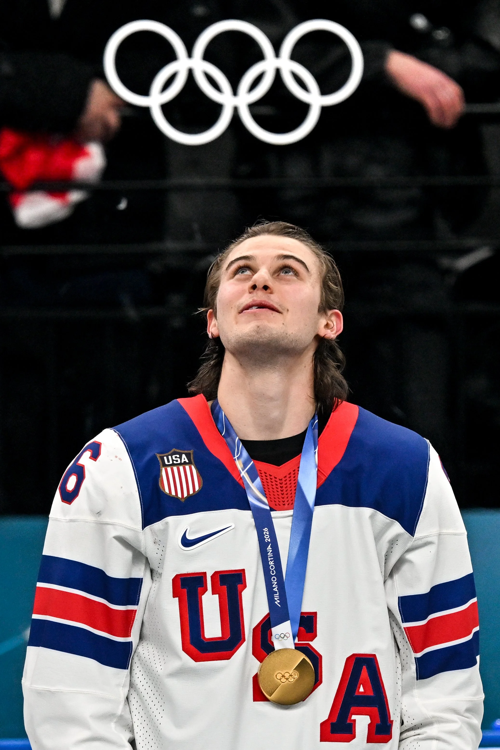  Jack Hughes looks toward the Olympic rings after winning the gold medal 