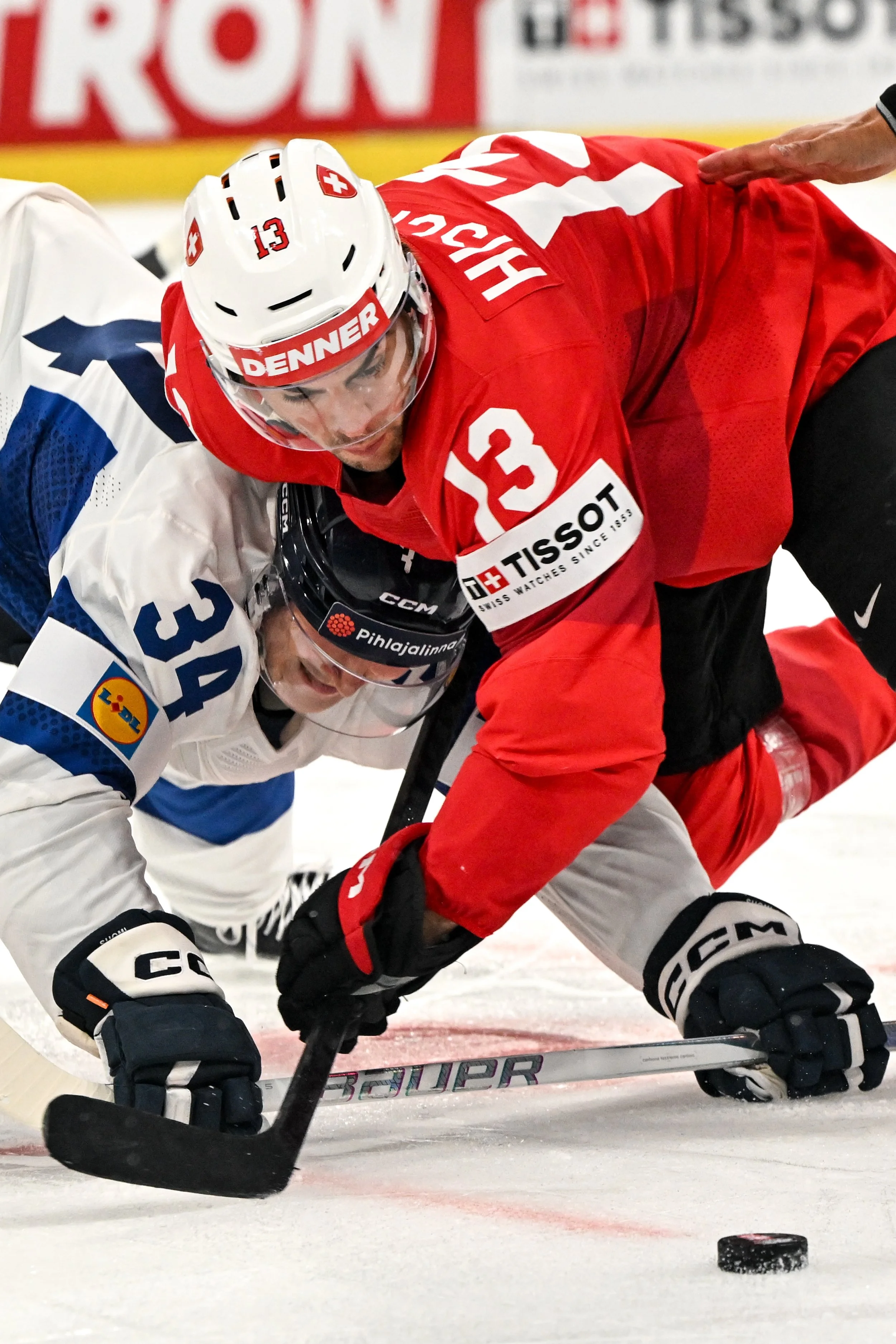 Aatu Räty and Nico Hischier battle for possession after a face-off 