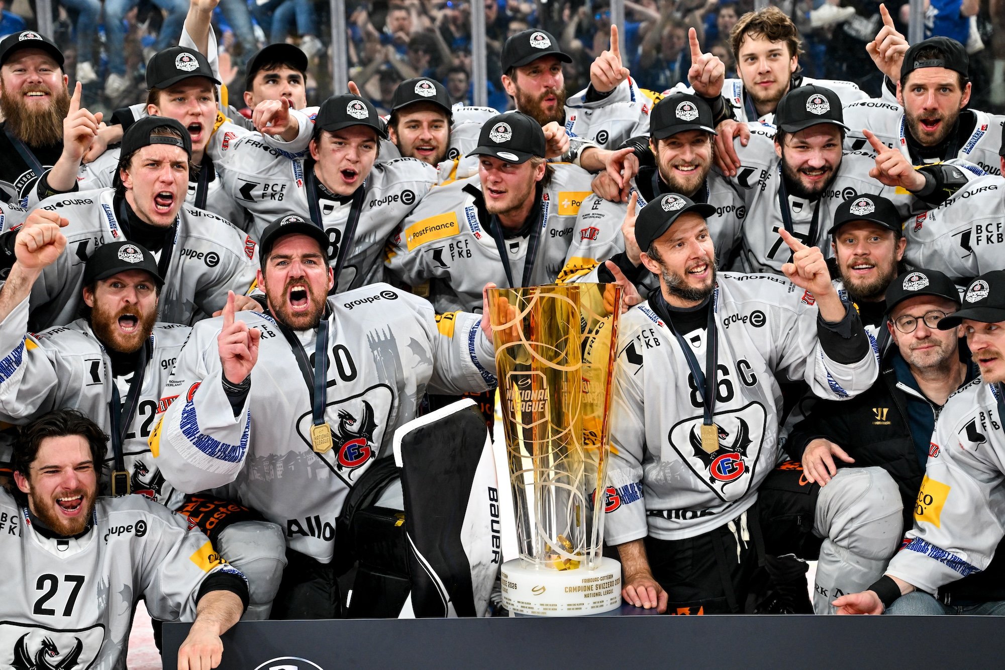  Fribourg players show their energy as they pose with the Swiss championship trophy 