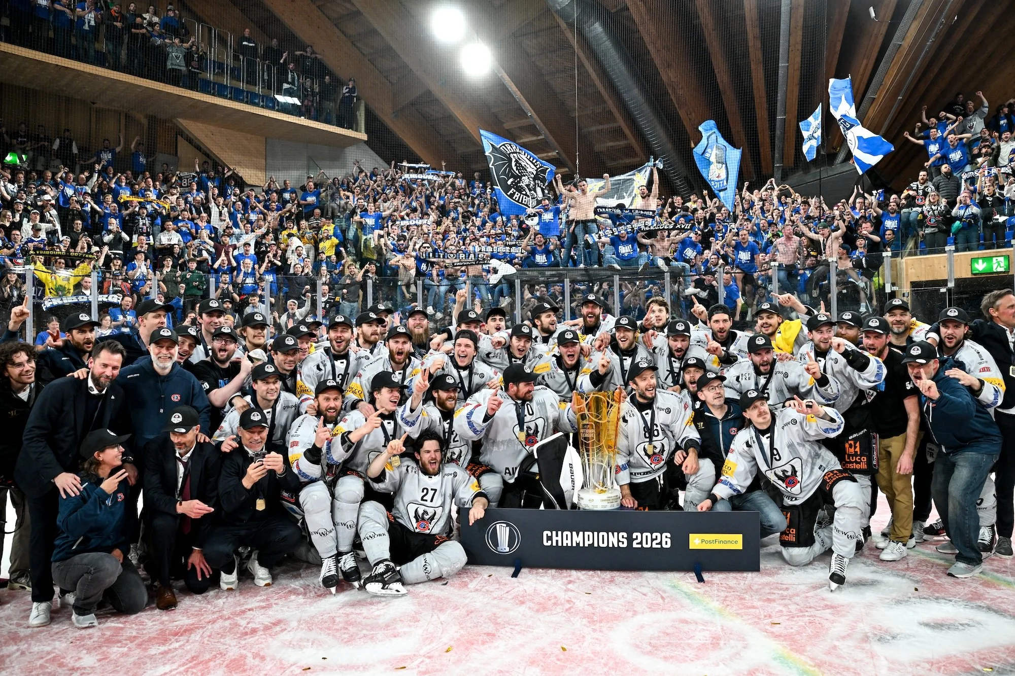  Fribourg poses with the trophy in front of its fans after defeating Davos in Game 7 of the final 