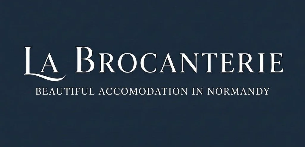 Image of a logo for La Brocante with the tagline 'Beautiful Accommodation in Normandy' on a dark background.