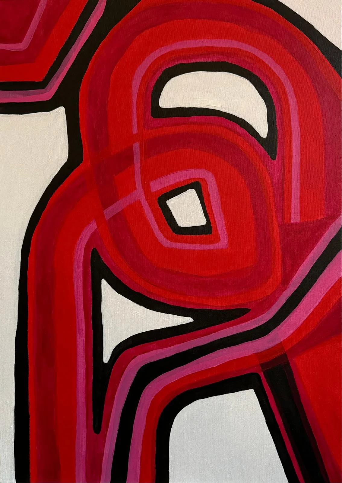 Close-up of an abstract mural with swirling red, pink, black, and white shapes.
