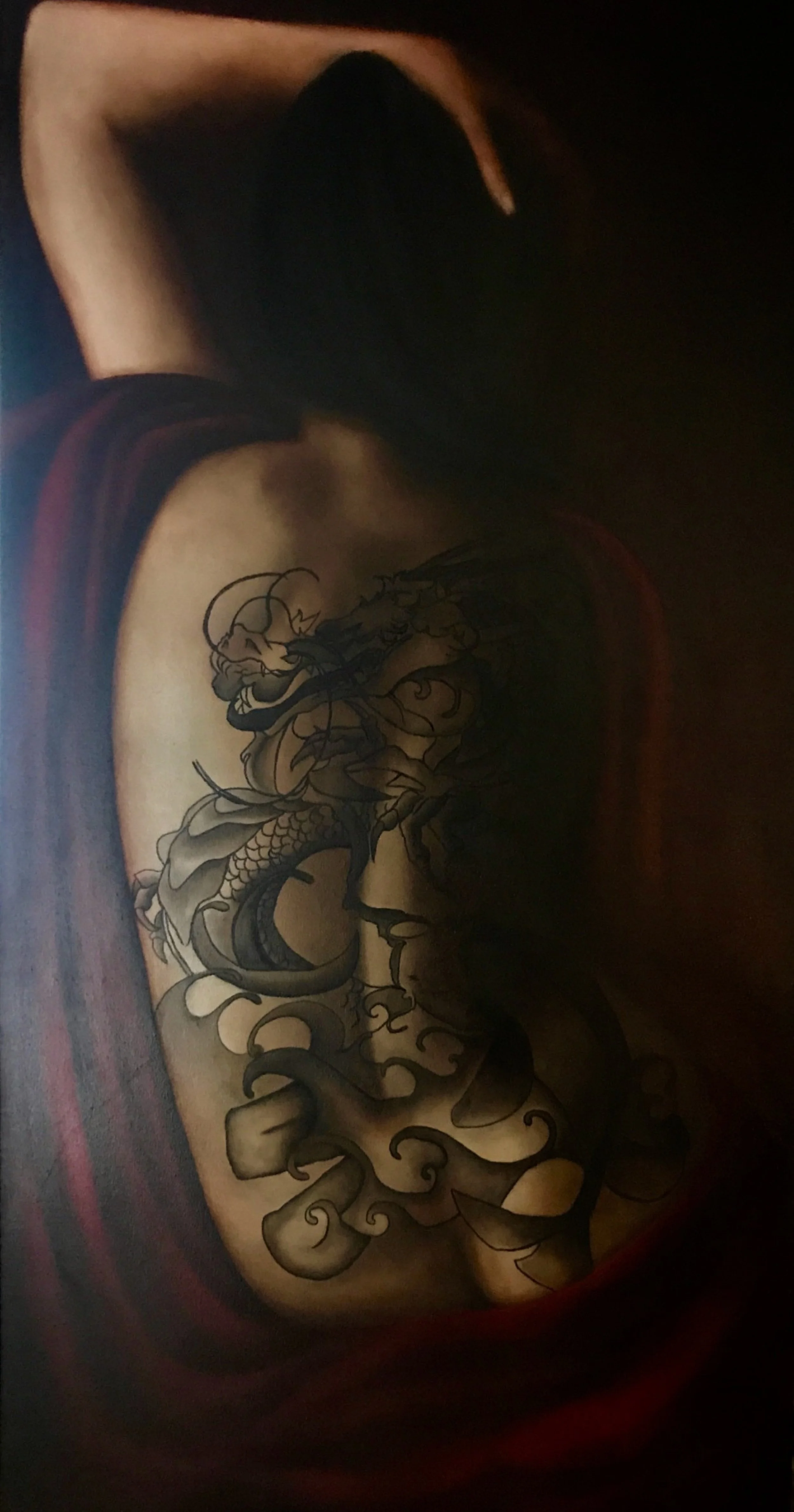 A tattoo of a dragon on a woman's back, featuring detailed scales, claws, and flowing smoke or clouds, in black and gray ink.