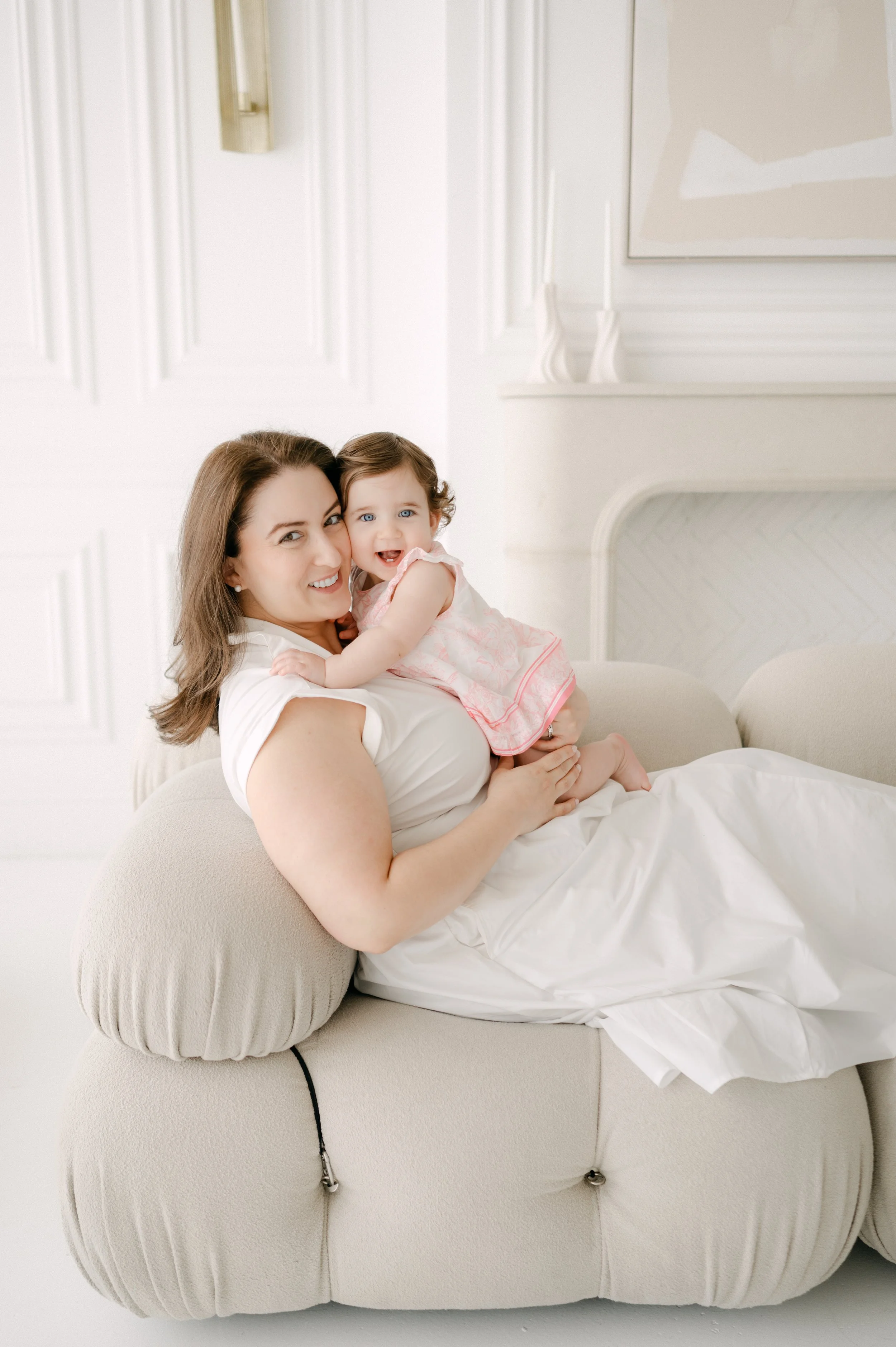 A mother holding her daughter in a bright calming room, reflecting healing and connection after placenta accreta spectrum (PAS) recovery.