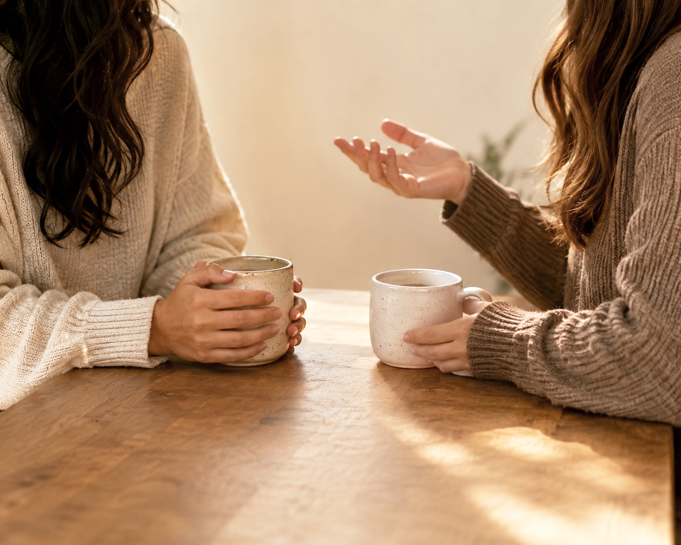 two women in a warm conversation over coffee, representing peer support and community connection central to PAS recovery.