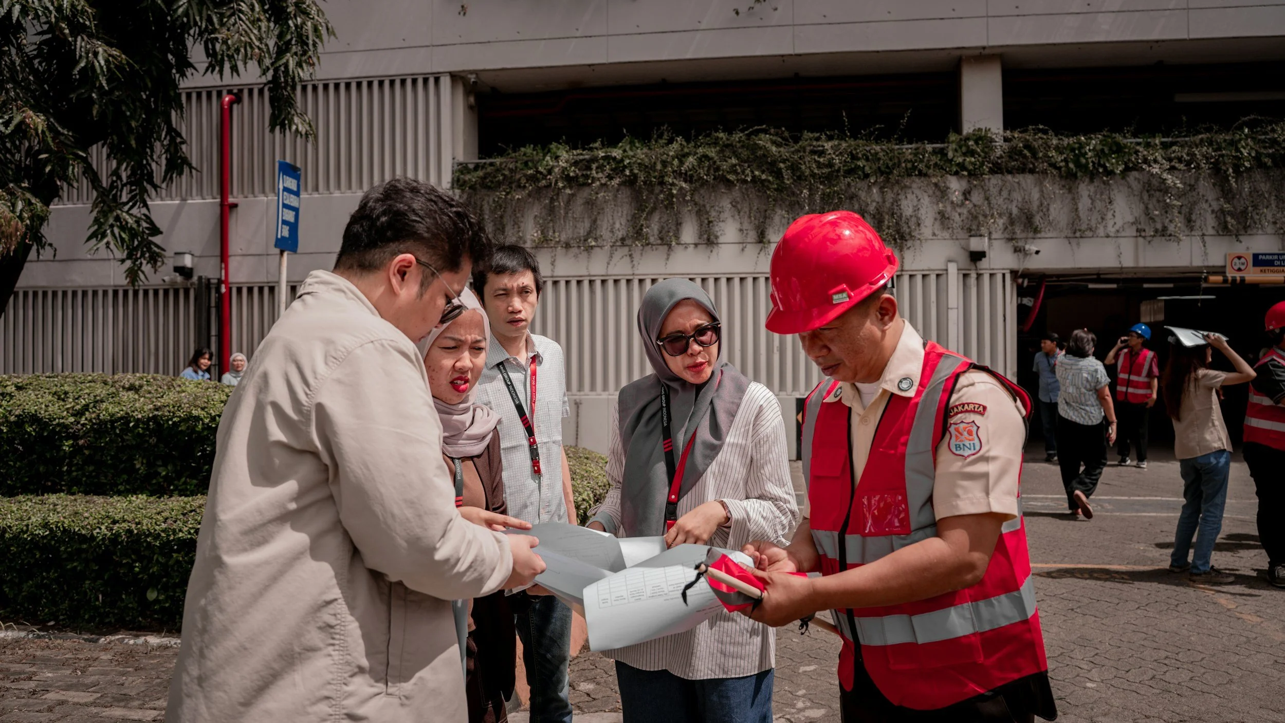 Stock image of several people meeting, some in PPE, some in casual clothes