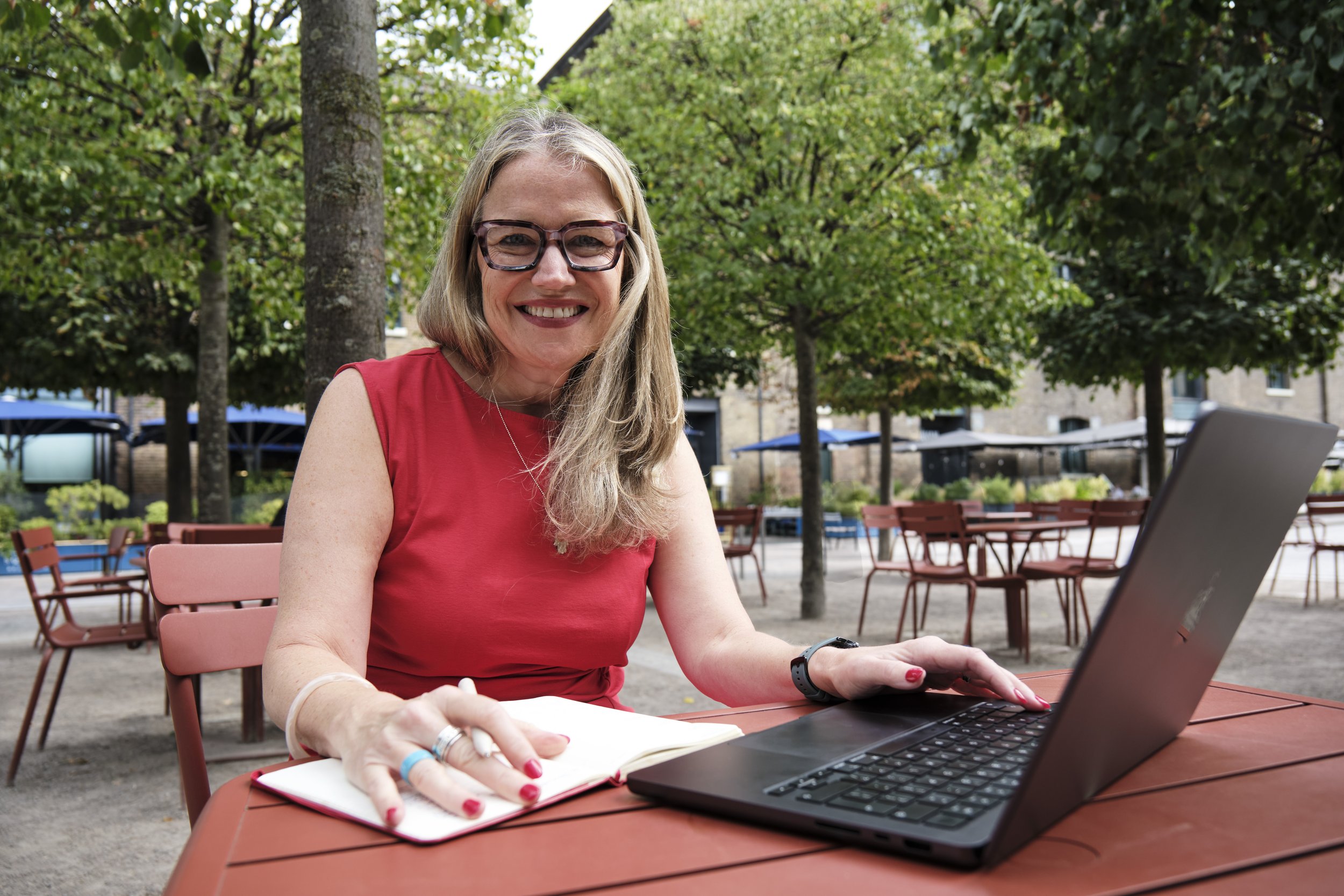 Debbie Porter sitting at an outdoor table.