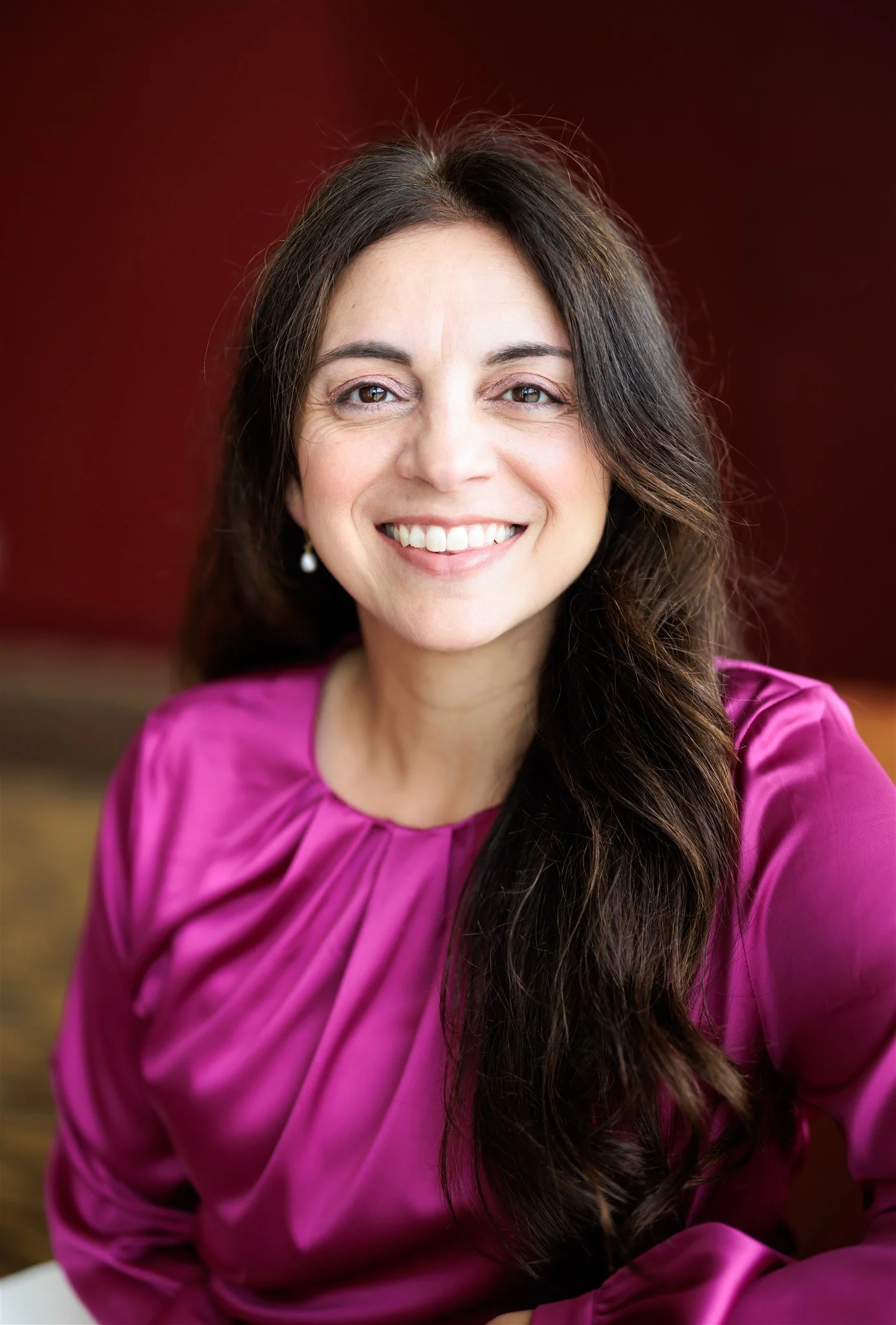 Headshot of Dr. Amanda Reyes in a pink top
