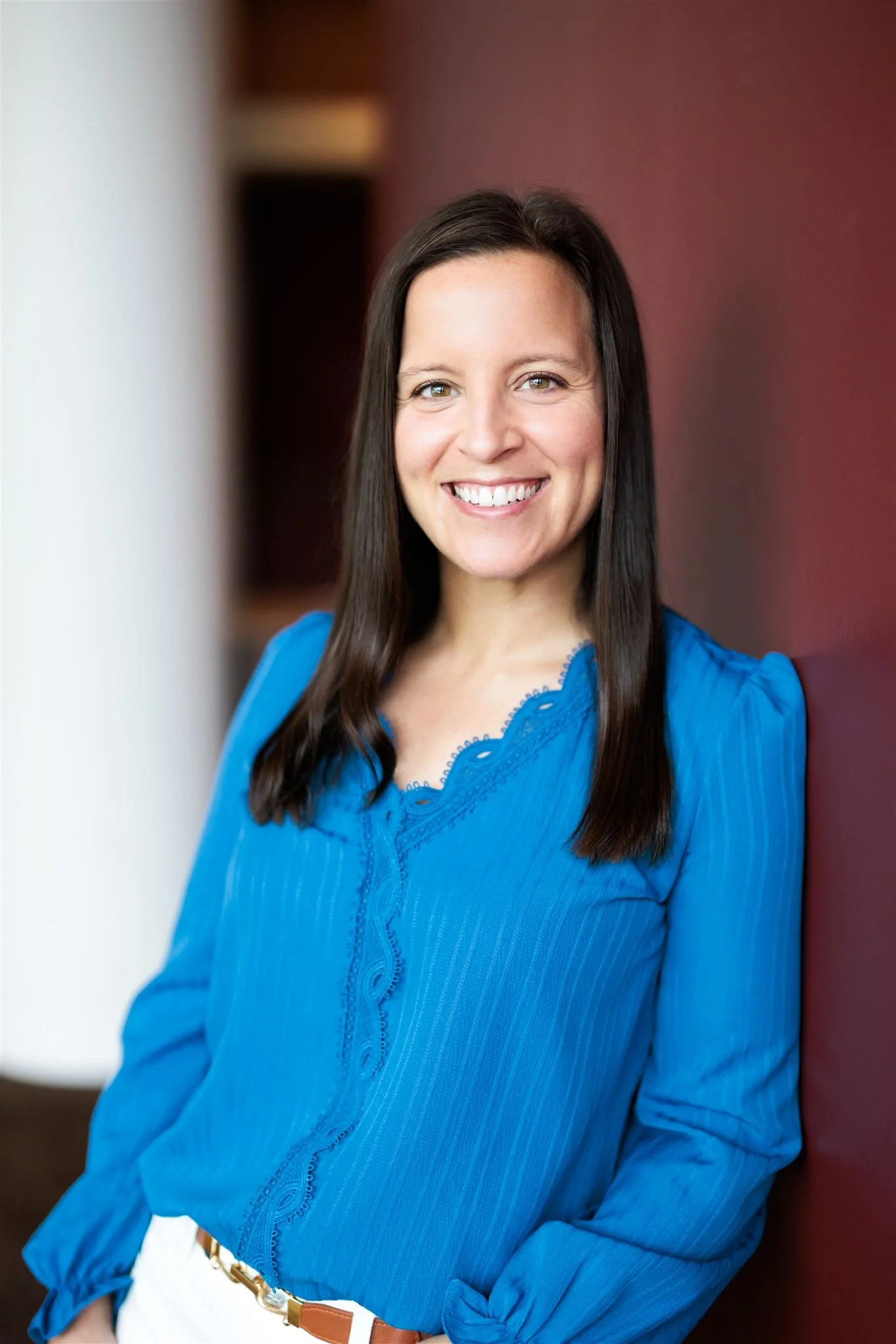 Headshot of Dr. Erica Behrens smiling at the camera and wearing a blue top