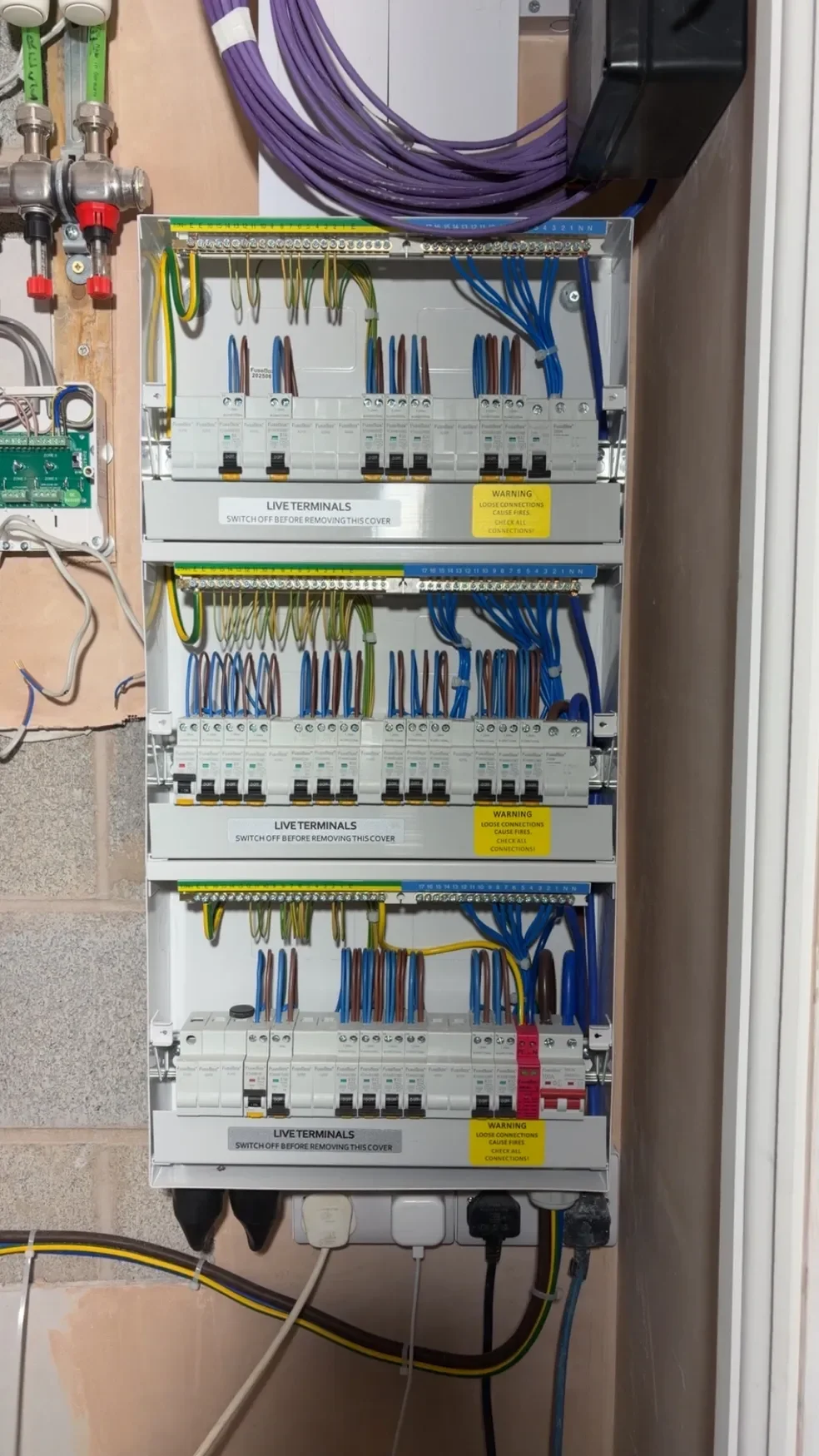 Electrical breaker panel with wiring connections, switches, and labels.
