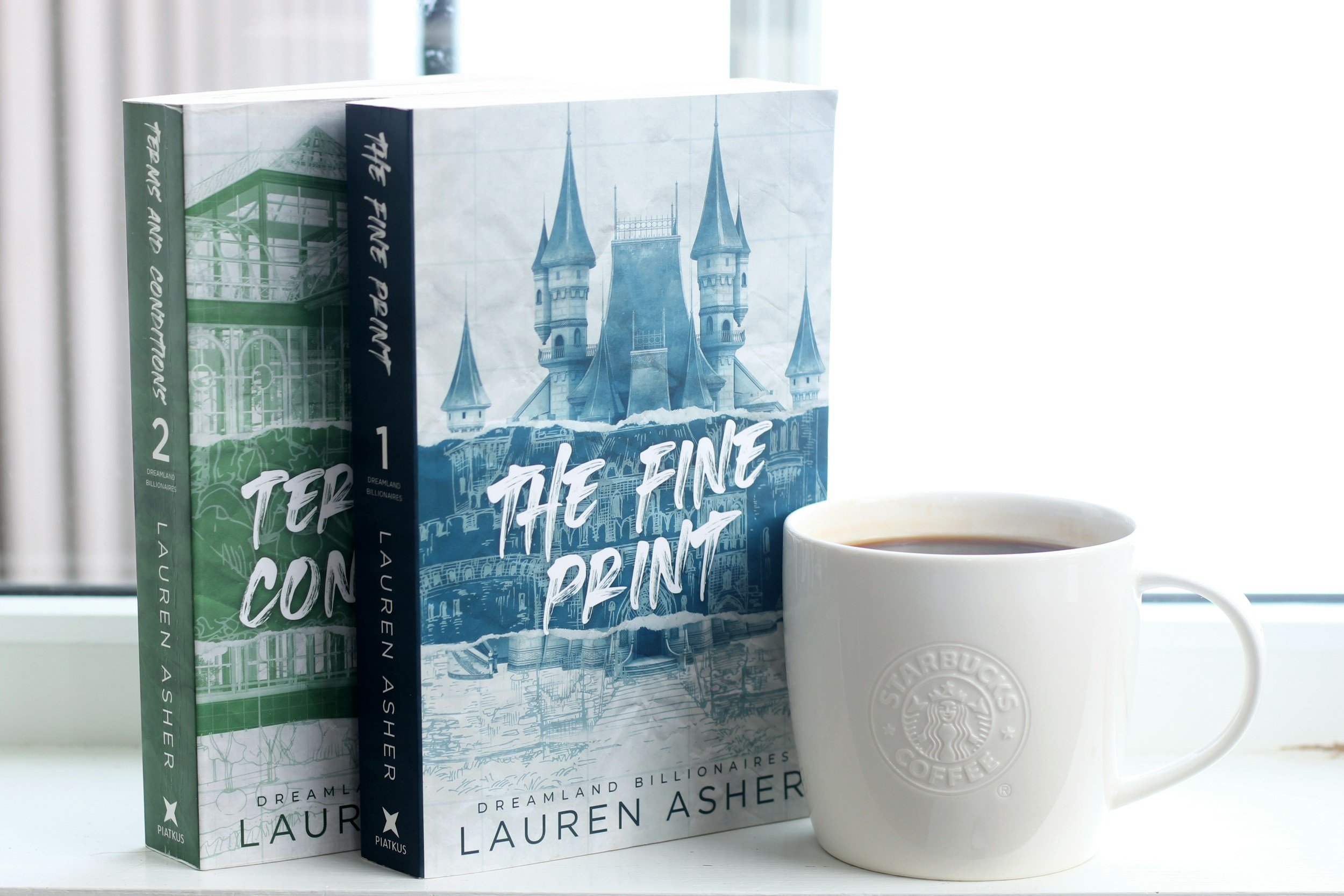Two books and a coffee on a shelf