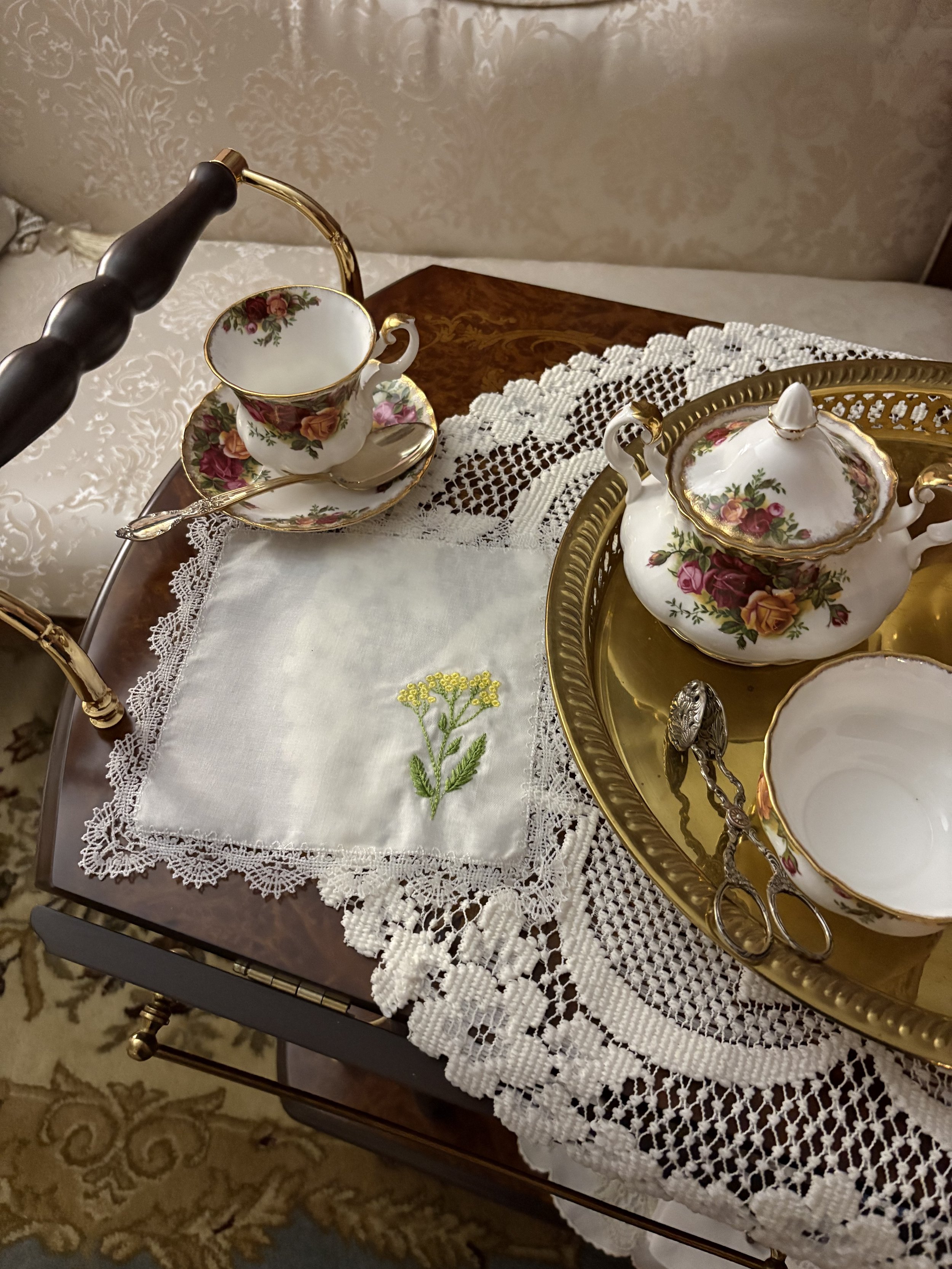 Embroidered yarrow handkerchief with heirloom lace trim, handcrafted in the Arkansas Ozarks and inspired by Victorian floral traditions.