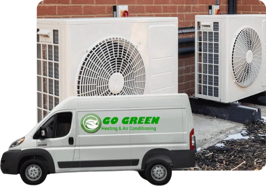 A white van with the text "GO GREEN Heating & Air Conditioning" parked in front of a building with two large HVAC units mounted on the outside wall.