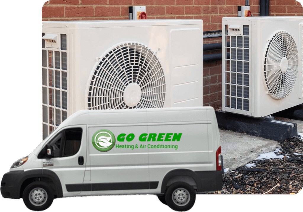 A white service van with the green logo and text 'GO GREEN Heating & Air Conditioning' parked on a concrete surface in front of two large outdoor air conditioning units against a brick wall.