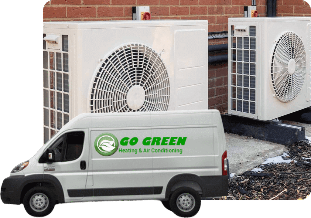 Commercial air conditioning units outside a building with a service van labeled 'Go Green Heating & Air Conditioning' parked nearby.