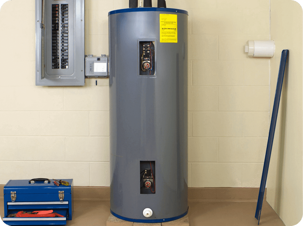An electric water heater tank installed next to an electrical panel, with a toolkit and a broom leaning against the wall.