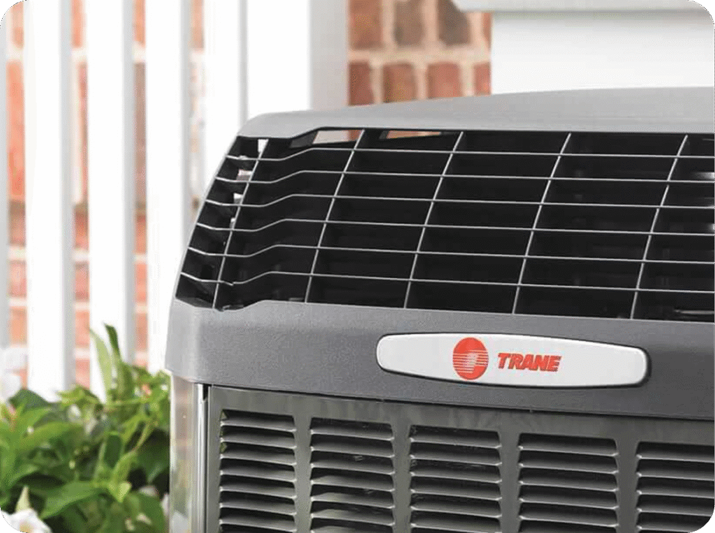 Close-up of a Trane outdoor air conditioning unit on a porch.