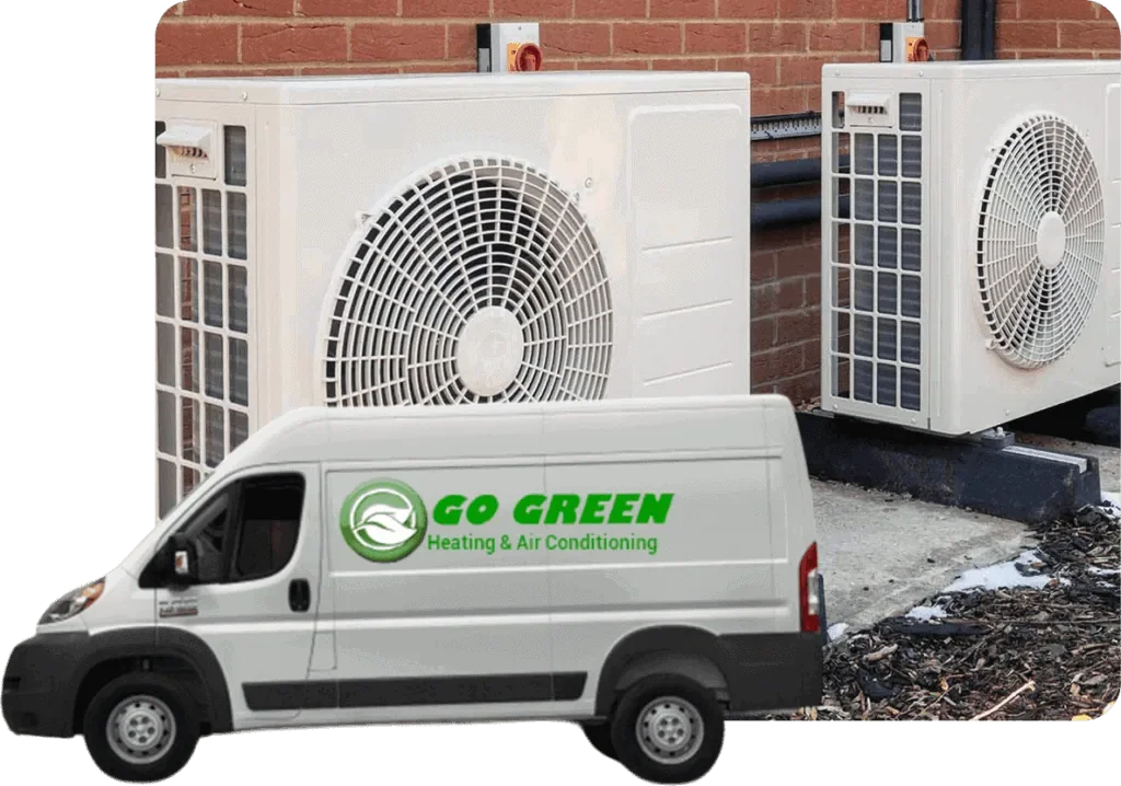 An air conditioning service van with the logo 'GO GREEN Heating & Air Conditioning' parked in front of two outdoor AC units next to a brick wall.