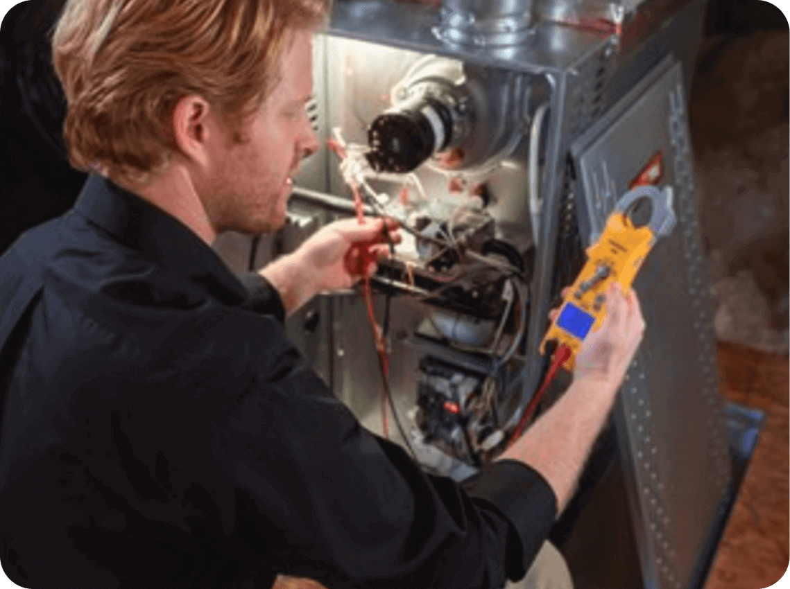 A technician repairing electronic equipment or appliance, using a multimeter with wires inside a partially disassembled machine.