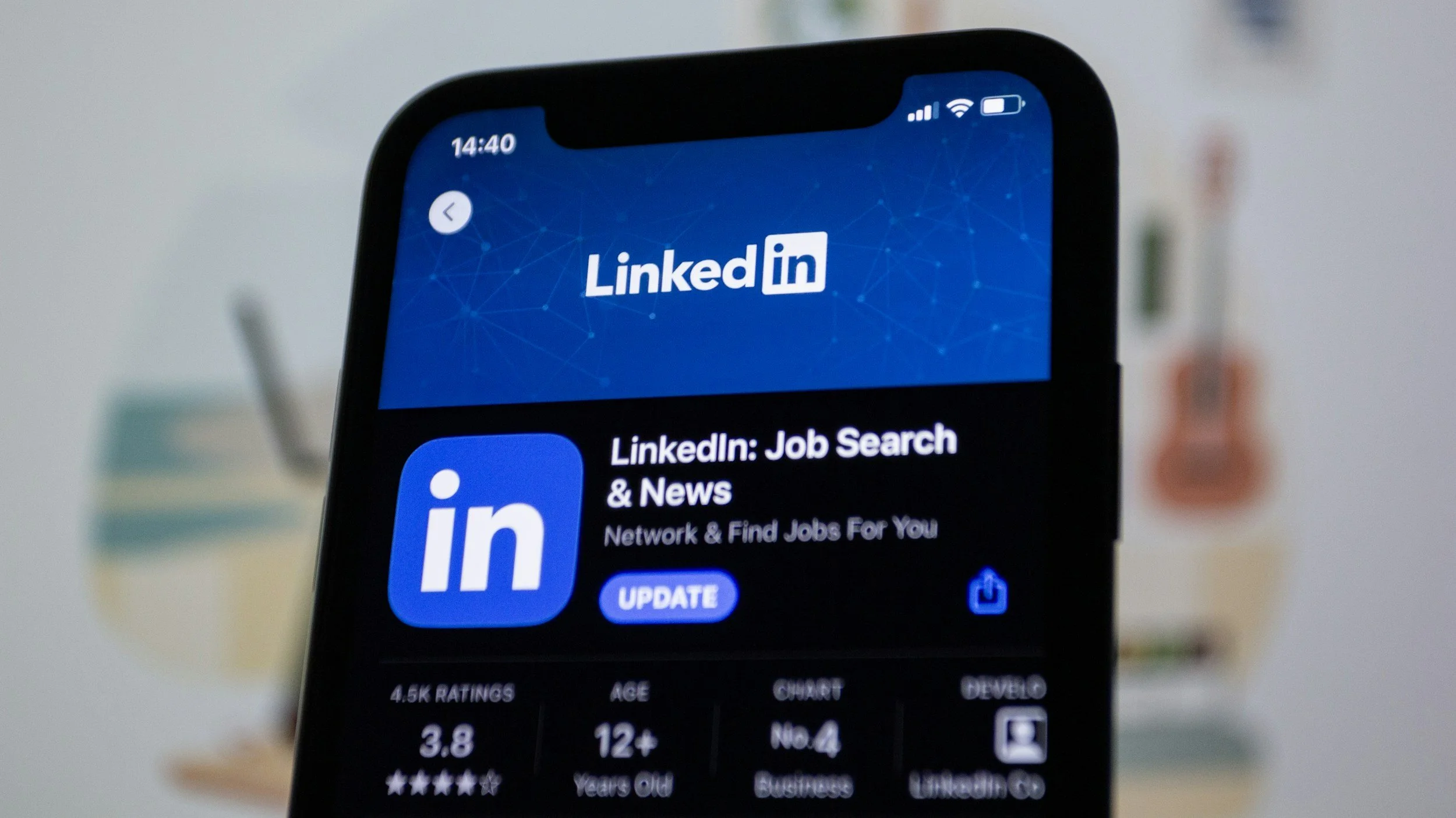 A smartphone screen displaying the LinkedIn app with the title 'LinkedIn: Job Search & News' under a blue header with network graphics, showing app ratings, age rating, chart, number of reviews, and update button.