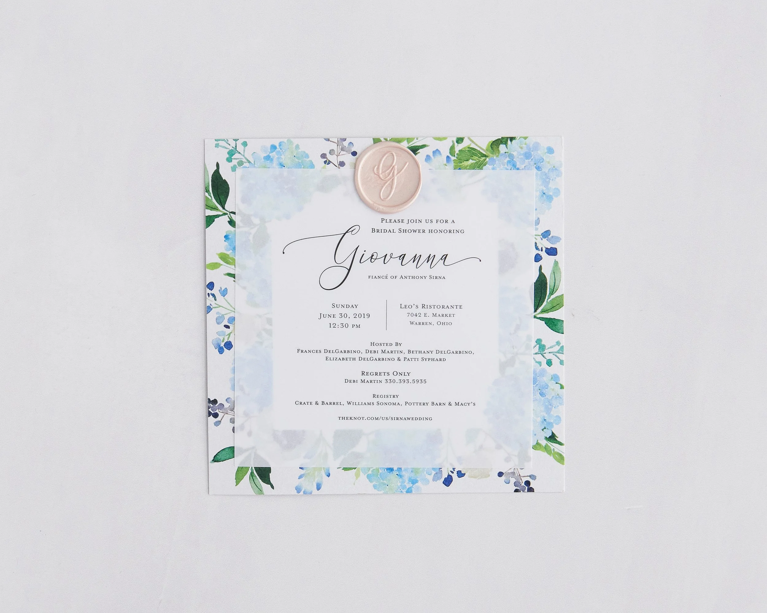 A wedding invitation with floral border, wax seal, and elegant script, inviting Giovanna to a bridal shower honoring her, scheduled for June 30, 2019, at Leo's Ristorante in Warren, Ohio.