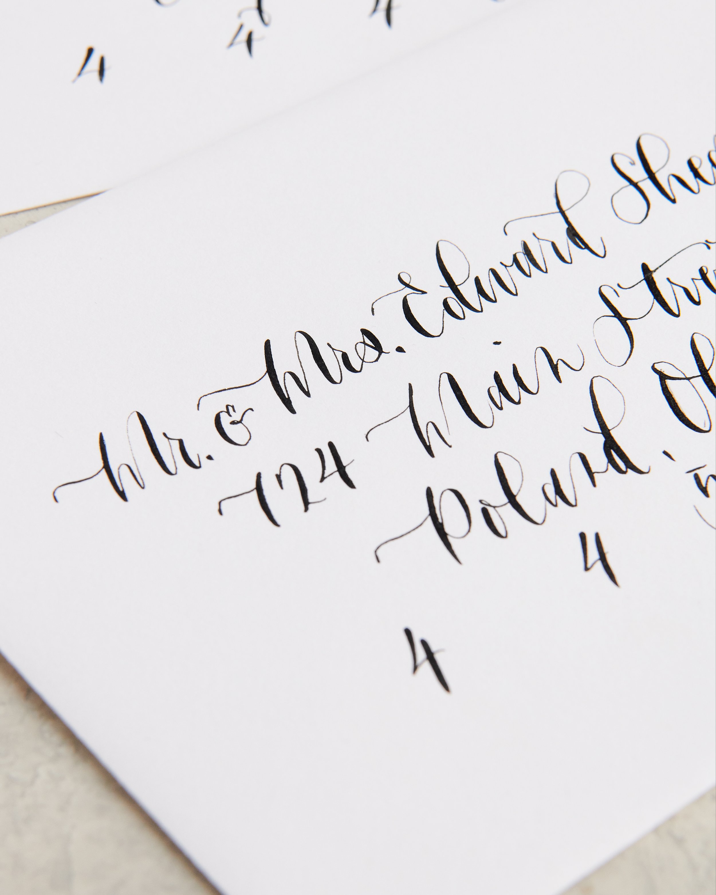Close-up photograph of handwritten cursive thank you message on white paper, focusing on the words 'thank' and 'you' with a blurred background.