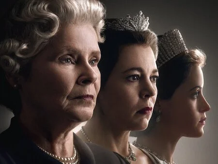 Image from the TV show "The Crown" featuring three women: an older woman with gray hair, a middle-aged woman with dark hair and a crown, and a young woman with light brown hair and a crown, all standing in profile against a dark background.