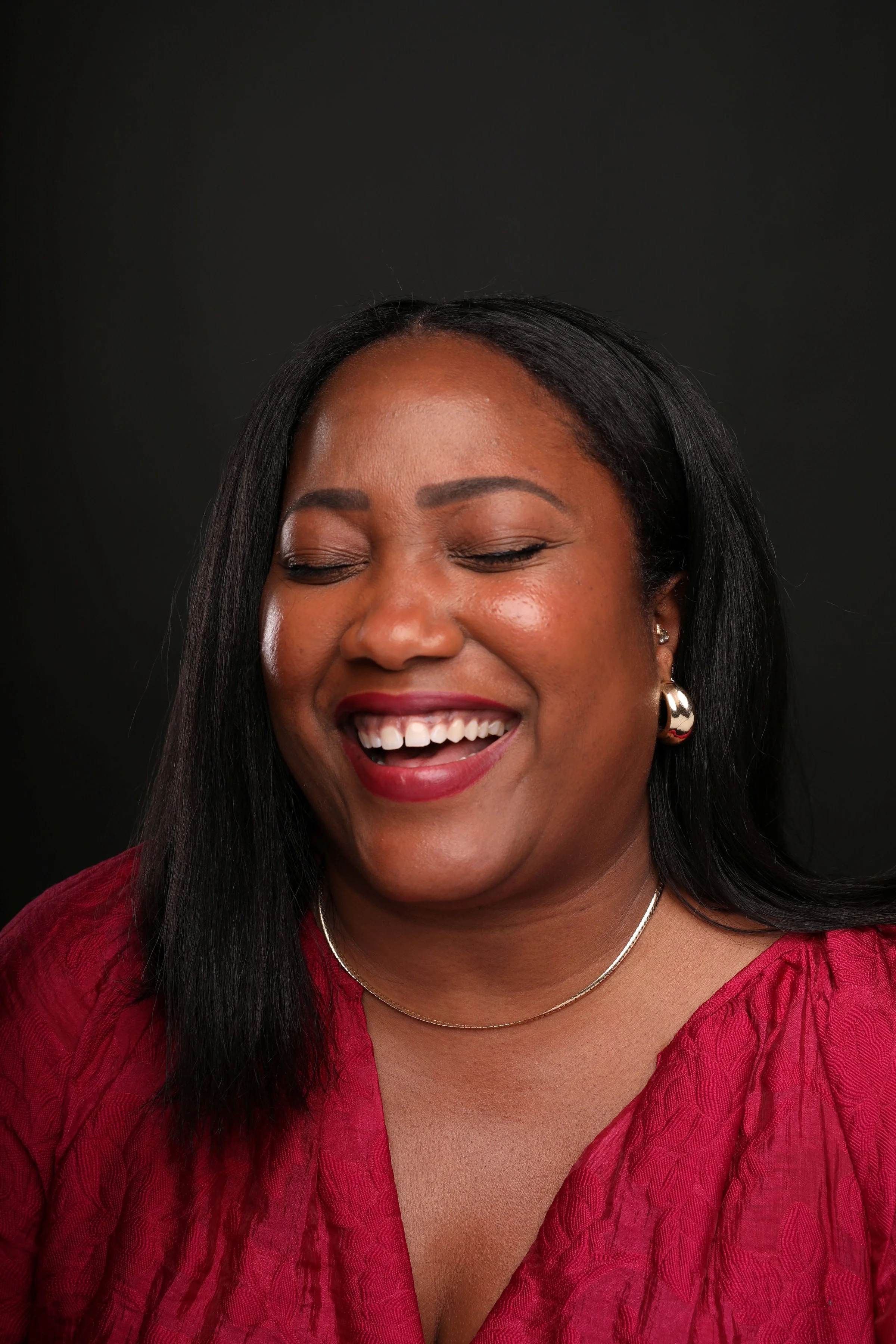 Quayla smiling excitedly with her eyes closed.
