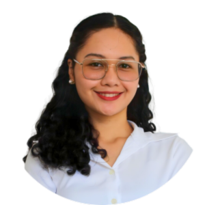 A young woman with curly dark hair, wearing glasses and a white collared shirt, smiling at the camera.