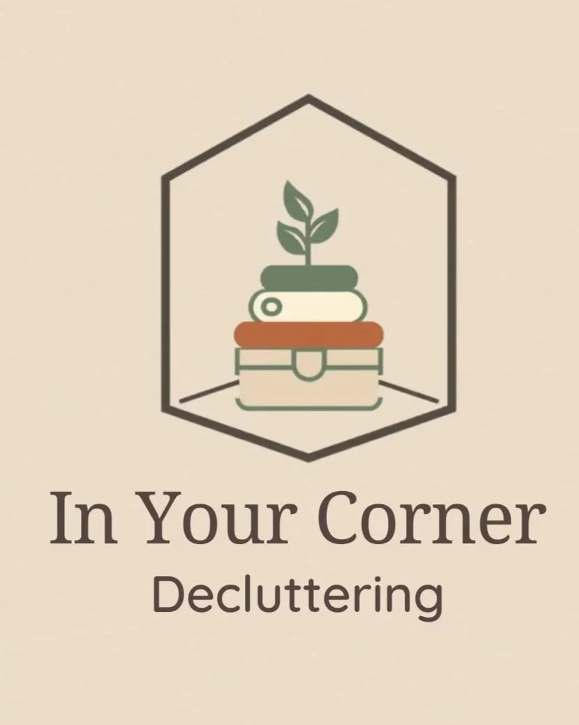 Logo with house outline, a stack of books with a plant sprouting on top, and the words "In Your Corner" and "Decluttering" underneath.