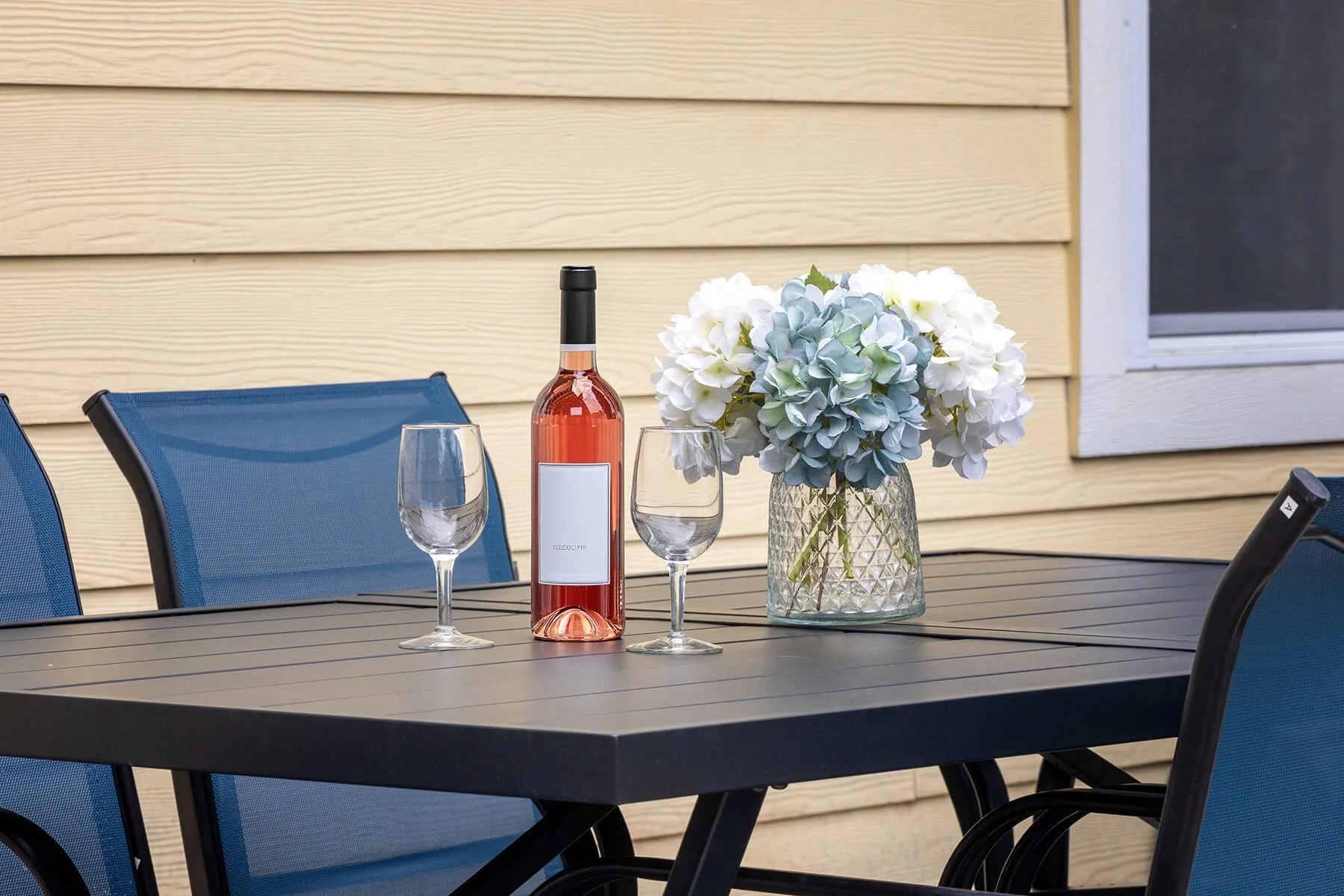 Outdoor dining patio with seating and coastal florals
