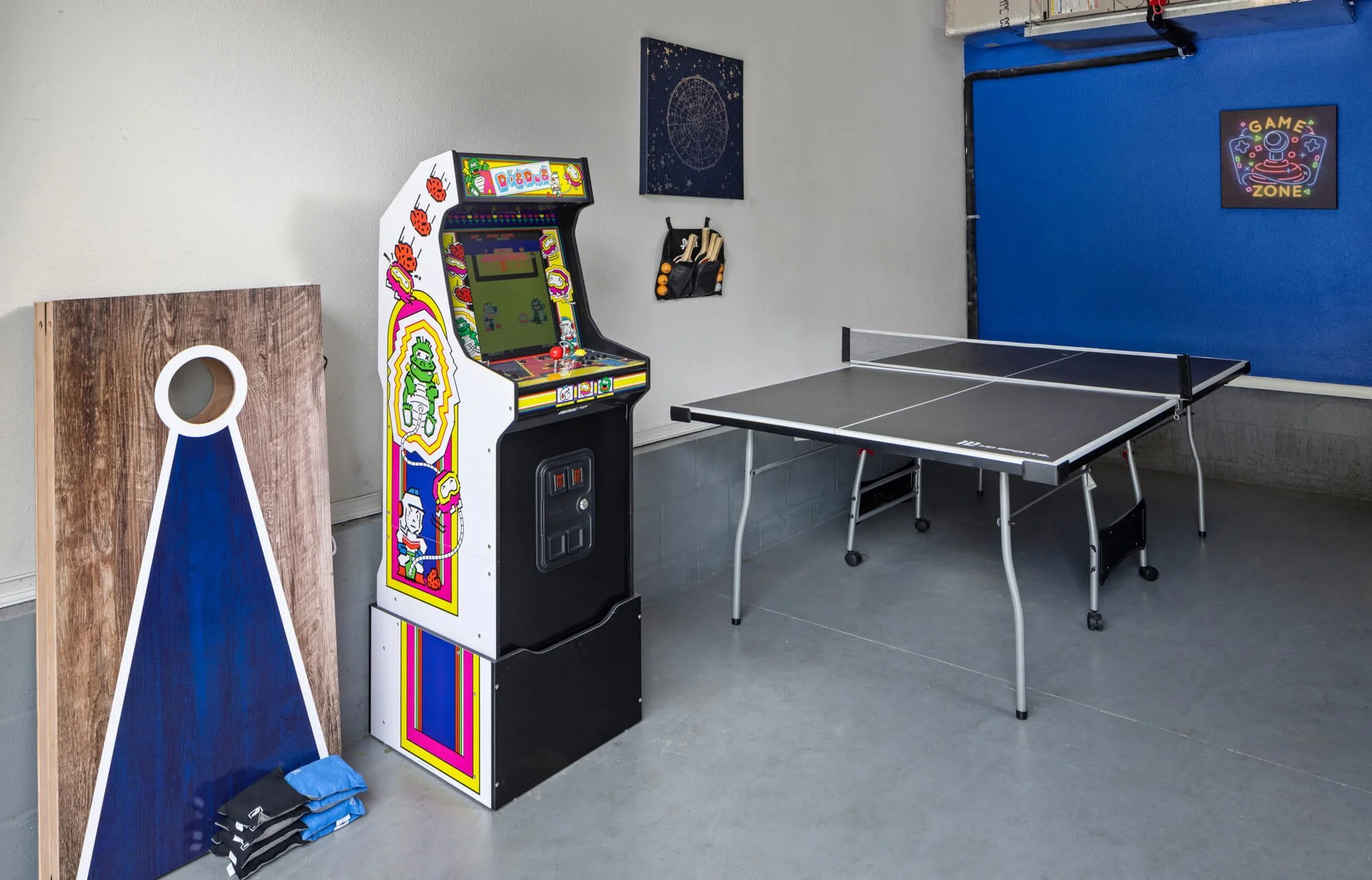 Game room with retro arcade machine, ping pong table, and cornhole