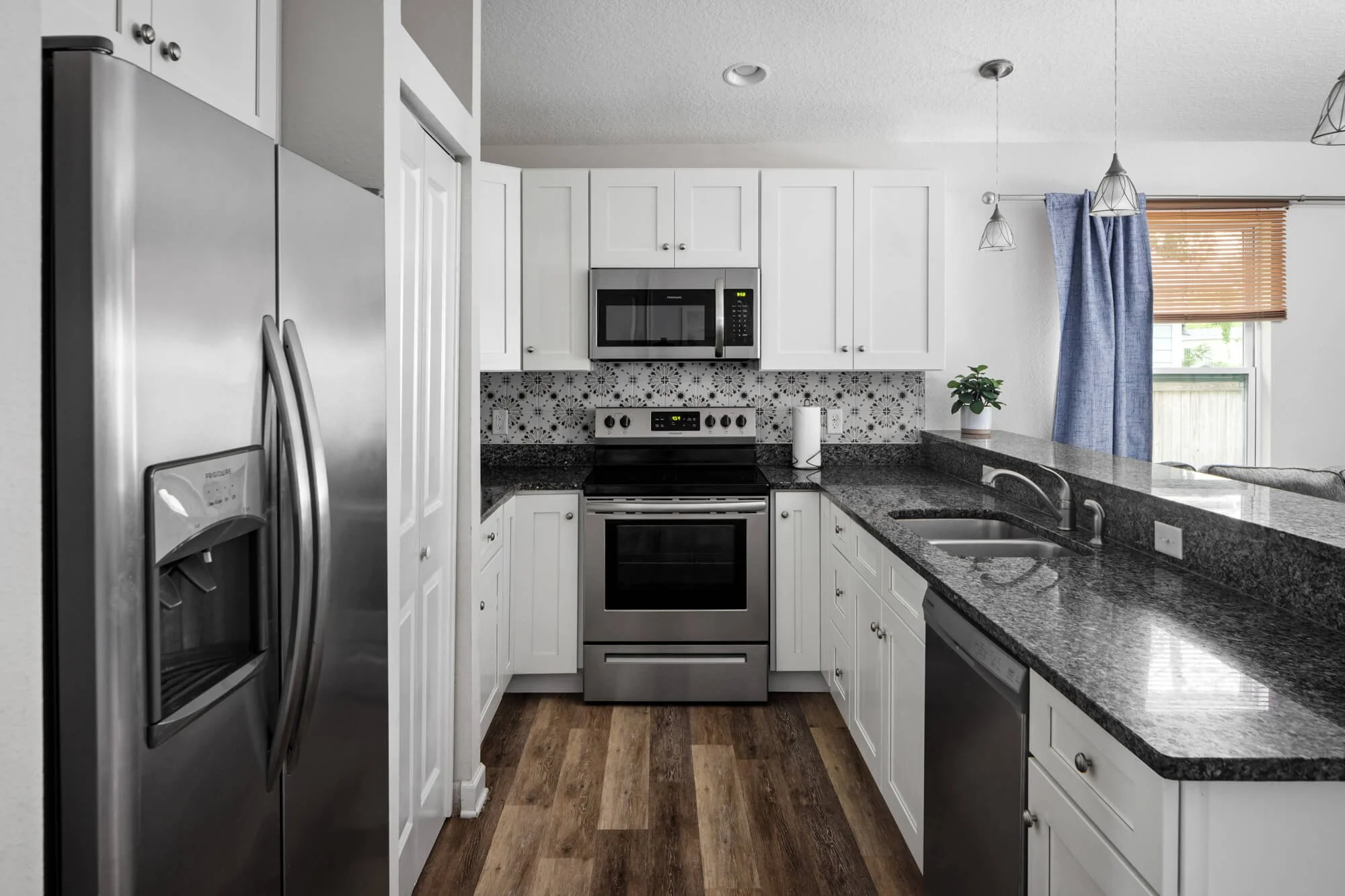 Fully equipped kitchen with stainless steel appliances and granite countertops